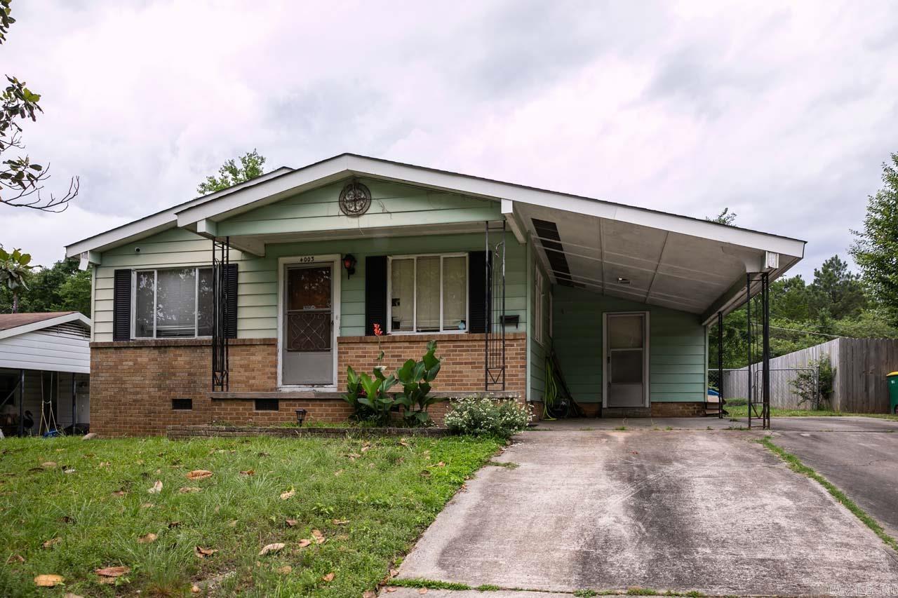 Nestled at the back of an established neighborhood and backing up to green space, this home is full of potential. Features include 3 bedrooms, hardwood floors, original built ins, a large den with a cozy stone fireplace, side porch, back deck, large laundry room that can double as a craft/workshop room with a half bath. Plenty of room to grow and make it your own!