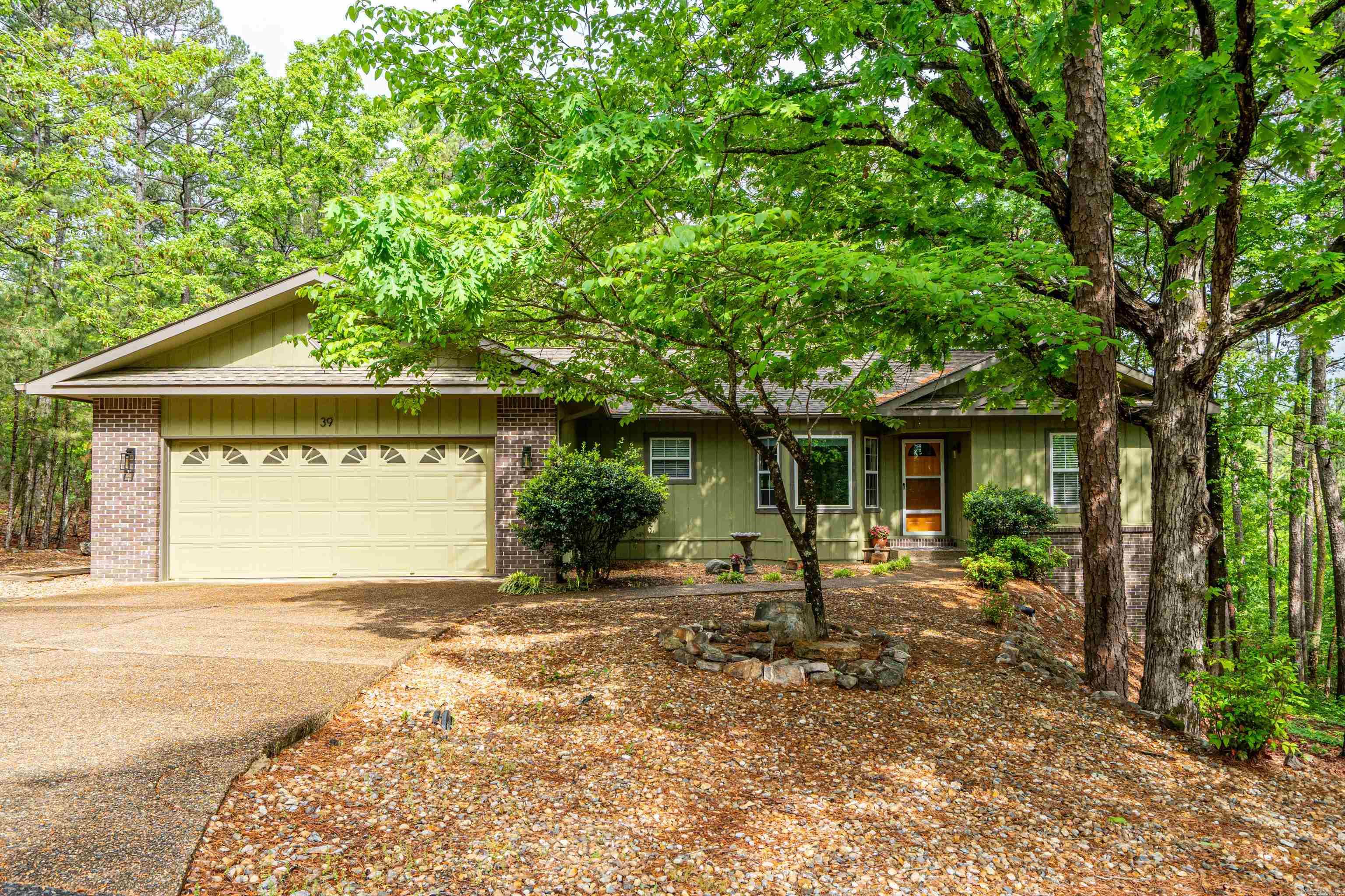 Private Retreat with Modern Updates – Ideal for Full-Time Living, Vacation Home, or Investment!  Tucked away in a peaceful, wooded setting, this 3-bedroom, 2-bath home offers privacy, seclusion, and strong potential as a primary residence, second home, or vacation rental. The level driveway and lot provide easy access, while the secluded backyard offers a tranquil escape with wildlife.  Inside, the split floor plan features vaulted ceilings, hardwood flooring, fresh paint, and new carpet in the bedrooms. The kitchen includes a new range and microwave, and all appliances convey—making it move-in or rental ready. A heated and cooled sunroom with walls of windows provides year-round enjoyment.  Enjoy the newly remodeled multi-level deck, plus a garage workshop and walkout basement with expansion potential. Located near Coronado Lake, boat ramp, fitness center, trails, golf, pickleball, dining, and more.