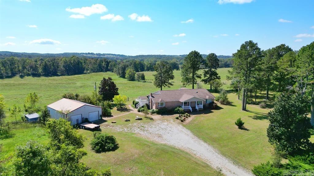 Welcome to your dream home! Nestled in a peaceful location with STUNNING 360-degree views. This spacious property offers tranquility and beauty at every turn. Featuring 4 bedrooms and 2 bathrooms, with a potential 5th bedroom or office space. This 2495 sq ft home provide ample space for any lifestyle needs. Situated on just shy of 2.5 acres, the property includes a 30x40 shop, perfect for your projects or storage needs. Imagine planting your dream garden or collecting fresh eggs each morning from your own chickens, all while enjoying the serene sounds of birds chirping and leaves whistling in the wind. The walkout basement is equipped with a concrete safe room, adding an extra layer of security and peace of mind. Don't miss the opportunity to make versatile property yours!