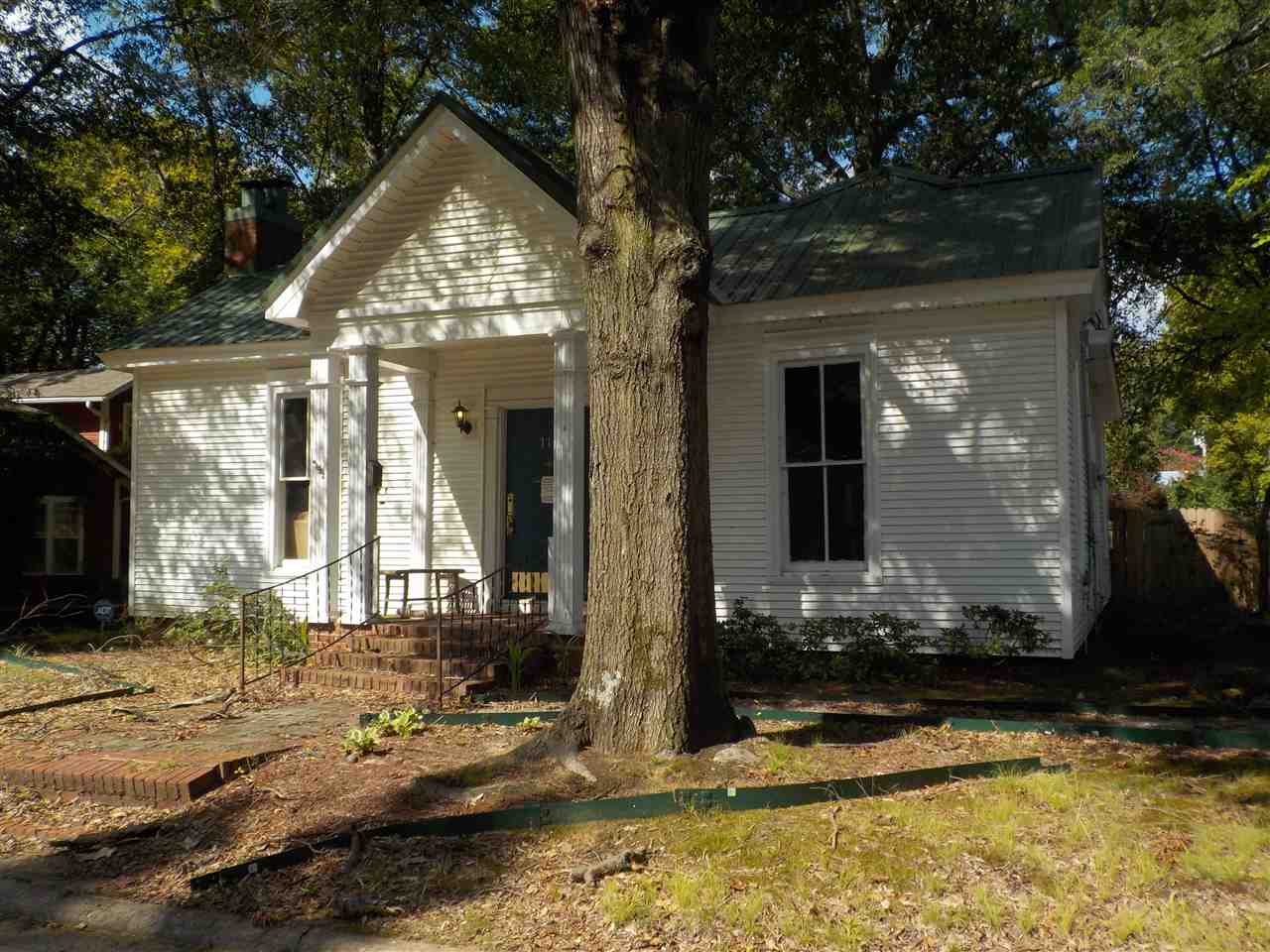 Adorable older home with wood floors, awesome yard, lots of decks for entertaining, storage building,  w metal roof.  Large kitchen with some updates.  Recently has been used for professionals office.  Many possibilites for this property.  Great home, air bnb, business or rental.   Sold as is.  Agents see remarks