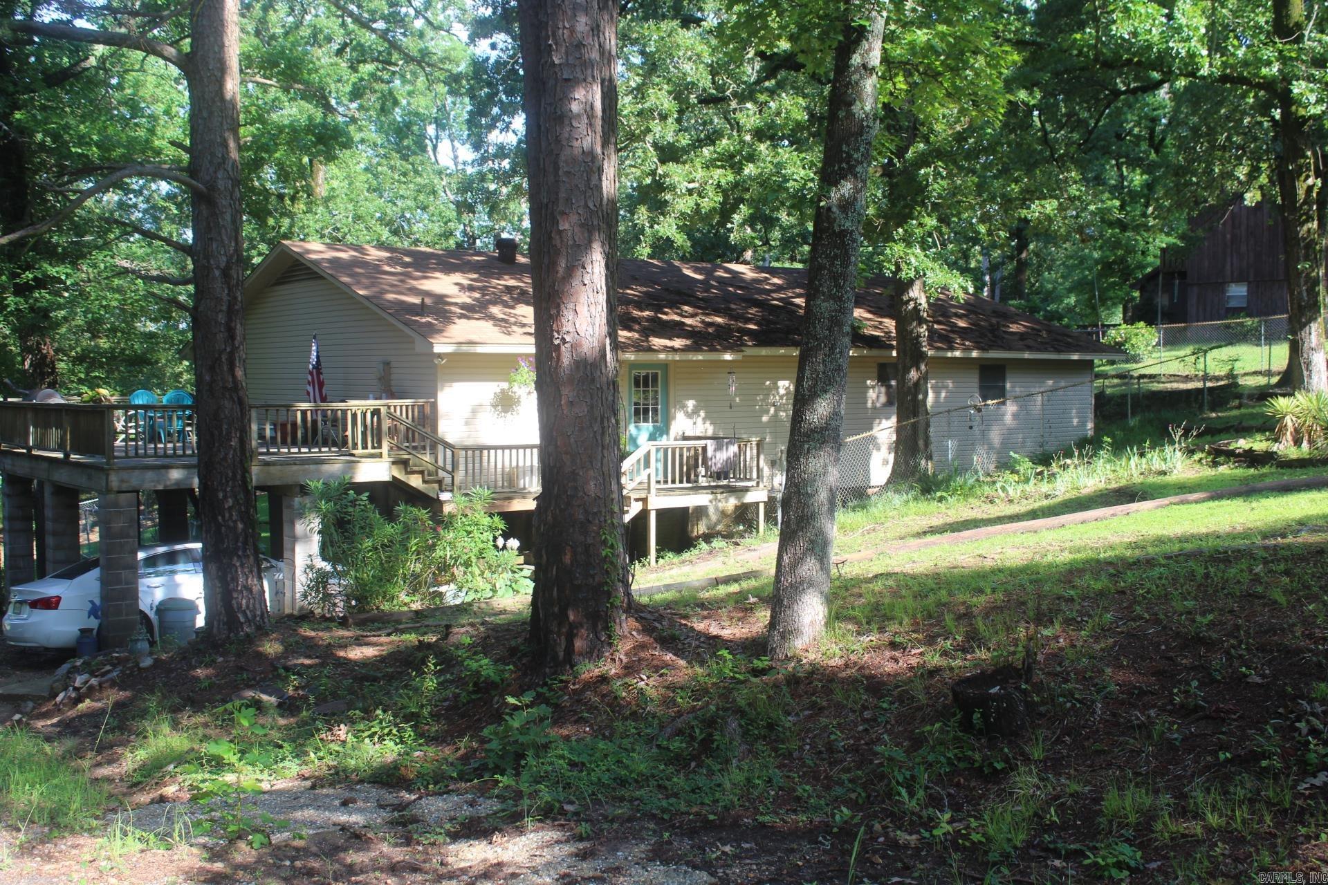 2 Bedroom, 1.5 Baths with approx. 1980 Sq. Ft. of living space.  Two living areas, main living area features fireplace, beamed ceiling.  Central AC & Heat.  Roof only 2 years old.  Large rear deck.  Located close to great fishing, duck hunting and Millwood Golf Club.  Range, Microwave and Refrigerator convey with sell of property.