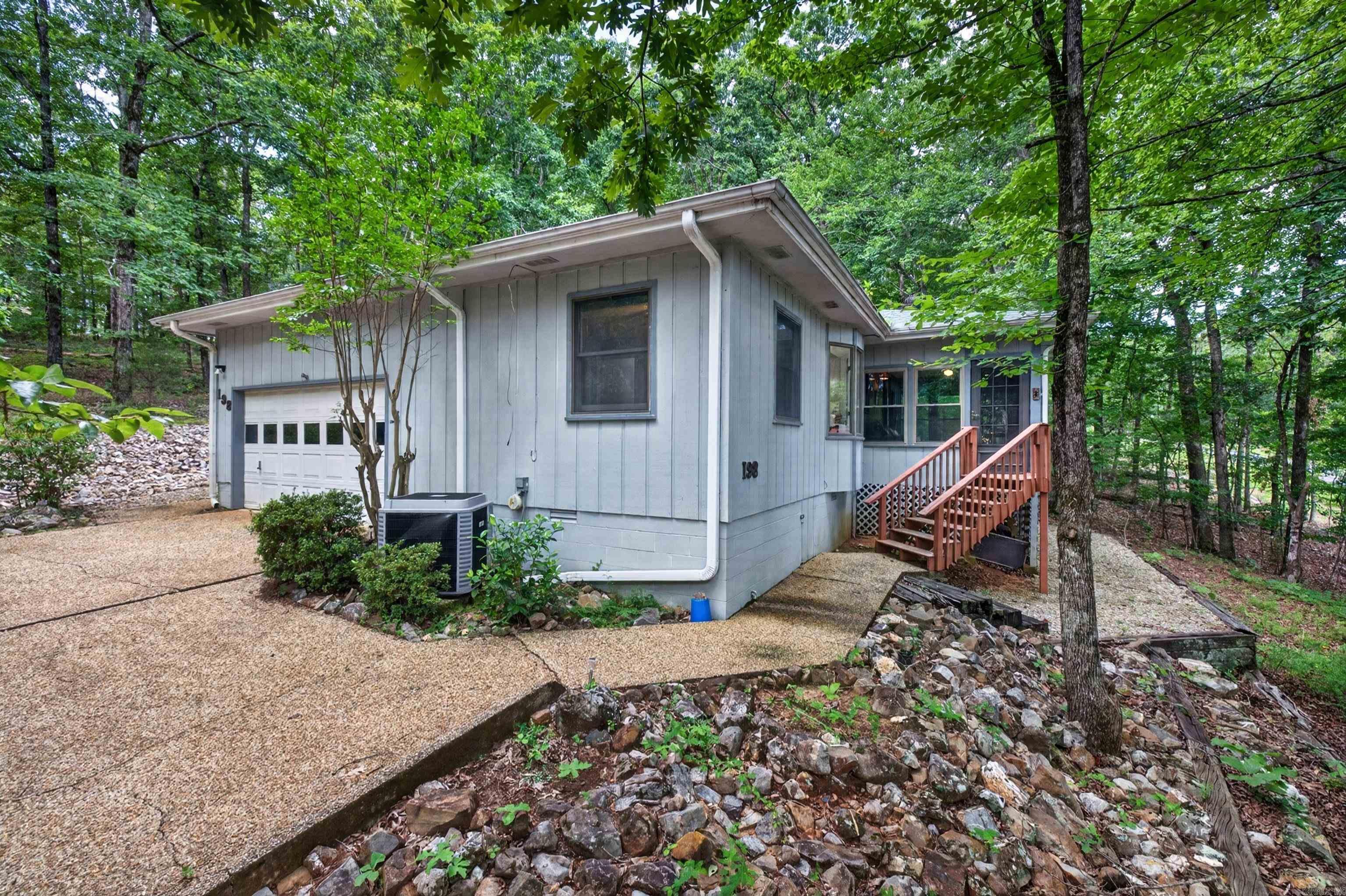 Enjoy this cute home on a private 1/3 acre lot between Lake Cortez and the Cortez Golf Course! Updated with a Bright Kitchen with Eating Area, Laminate Flooring in the Living Room with Cathedral Ceiling, and a 200 sq ft Arkansas Room with a View of Nature you will surely enjoy! The Master Bedroom with Ensuite boats a Jetted Tub and a Walk-in Closet! A 2 Car Garage makes this an even better value at this price! This home is turn-key ready for an owner or as a quality rental opportunity! 26,000 gated acres in Hot Springs Village boasts 11 Lakes & 9 Golf Courses, Tennis, Pickleball, Fitness Center, 2 Pools, 2 Marinas, 20+ Restaurants, Walking Trails, and much more!