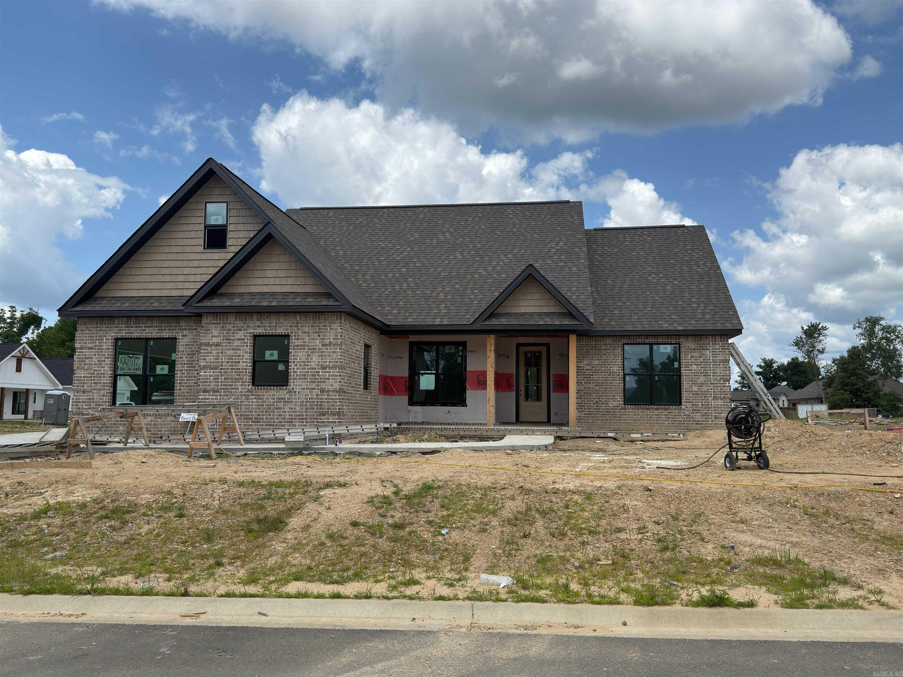 UNDER CONSTRUCTION in the highly sought-after Lake Hamilton School District! This stunning 1,561-square-foot all-brick home in Walkway Point offers the perfect blend of quality, location, and modern efficiency. This thoughtfully designed single-story layout features three spacious bedrooms and two full baths, along with a versatile bonus room perfect for a home office or playroom. Built for long-term savings, this home includes energy-efficient appliances, a 95% high-efficiency furnace, and a tankless gas water heater. The heart of the home is a designer kitchen highlighted by a large granite island that flows seamlessly into the expansive great room, making it ideal for entertaining. You will find high-end finishes throughout, including durable laminate and tile flooring (no carpet), energy-efficient insulated windows, and a sleek all-brick exterior. Complete with a welcoming front porch and a level lot just minutes from Lake Hamilton, this brand-new build is a premier choice for those seeking a high-performance home in a top-tier school district.