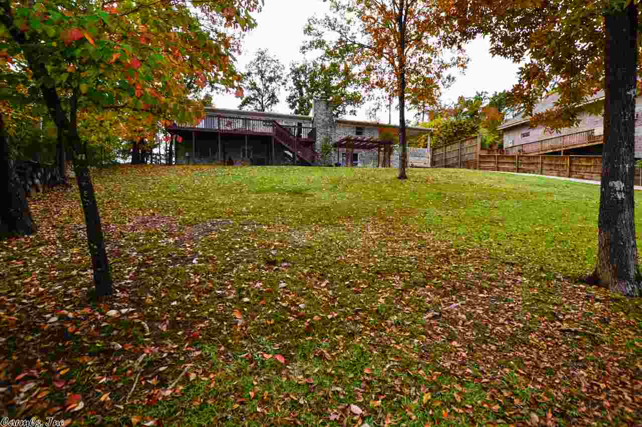 Comfy & spacious two-story 3,011 square foot blonde brick home located on Lake Hamilton consists of 4 bedrooms, 2 full baths and two living quarters. The main level has a nice open floor plan with the kitchen, dining & family room flowing together, with a full bath with a double-sink vanity, a huge master bedroom, and a really large laundry room. The master bedroom was originally two bedrooms that was converted to one, so there's plenty of space for large furniture while still having a nice sitting area...