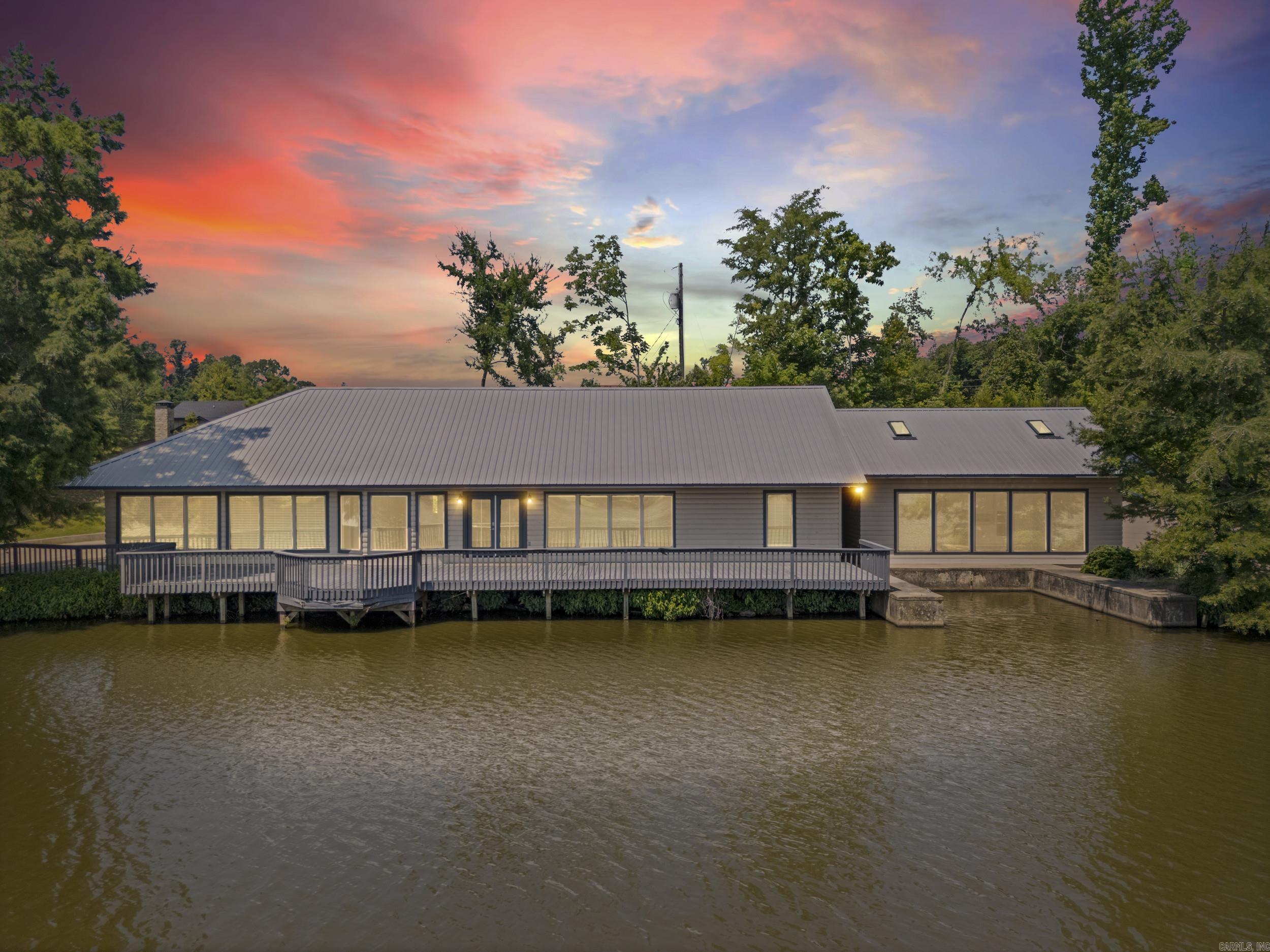 Experience the perfect blend of modern design and peaceful lakefront living at 20 County Road 348 in Wynne, Arkansas.  Situated on approximately 1 acre along Hunter's Rest Lake, this impressive 3,680-square-foot home offers the space, style and setting you've been searching for.  From the moment you step inside, you'll be welcomed by abundant natural light, panoramic lake views and an open-concept floor plan designed to bring people together.  The expansive living room flows seamlessly into the kitchen/dining room creating the perfect gathering space for family and friends.  Outside the views steal the show.  Whether you're enjoying your morning coffee on the patio, hosting friends, or unwinding as the sun sets over the water, the lake view creates a peaceful backdrop you'll enjoy year around.  As a homeowner, you'll enjoy exclusive access to a 38-acre private lake and 80 acres of scenic Crowleys Ridge beauty.  Complete with modern finishes, durable metal roof, and a private boat dock, this exceptional lakefront property offers the perfect blend of luxury, comfort, and outdoor adventure.  Don't miss your opportunity to own one of Crowley's Ridge's most unique waterfront homes.