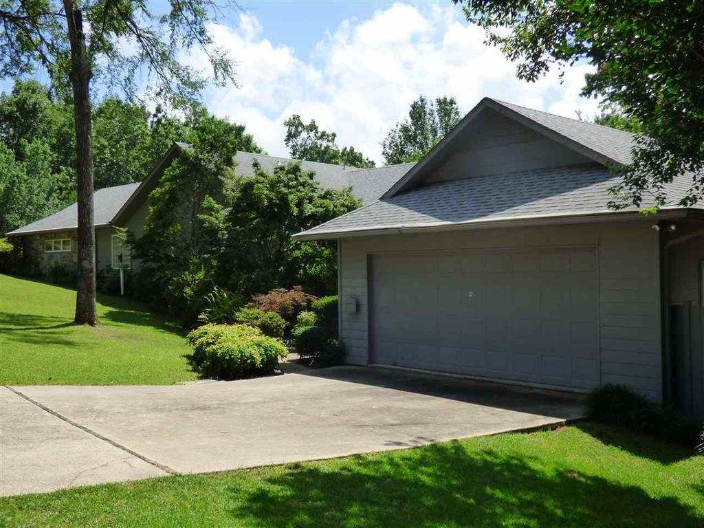 You must see this to believe it.  Looks like new and lives big!  Garage wired for generator.  Safe room with inside-outside access and 1/2 bath.  Main house is 3/2 with open split floorplan,(no halls), office, huge master suite, living dining combo, fireplace, covered deck with potting shed underneath.  4 Car Garage! Security System, fenced yard, professionally landscaped.  S.F. includes basement room and heated and cooled detached garage/shop with full bath!  Majestic Lodge Boat ramp just down the street.