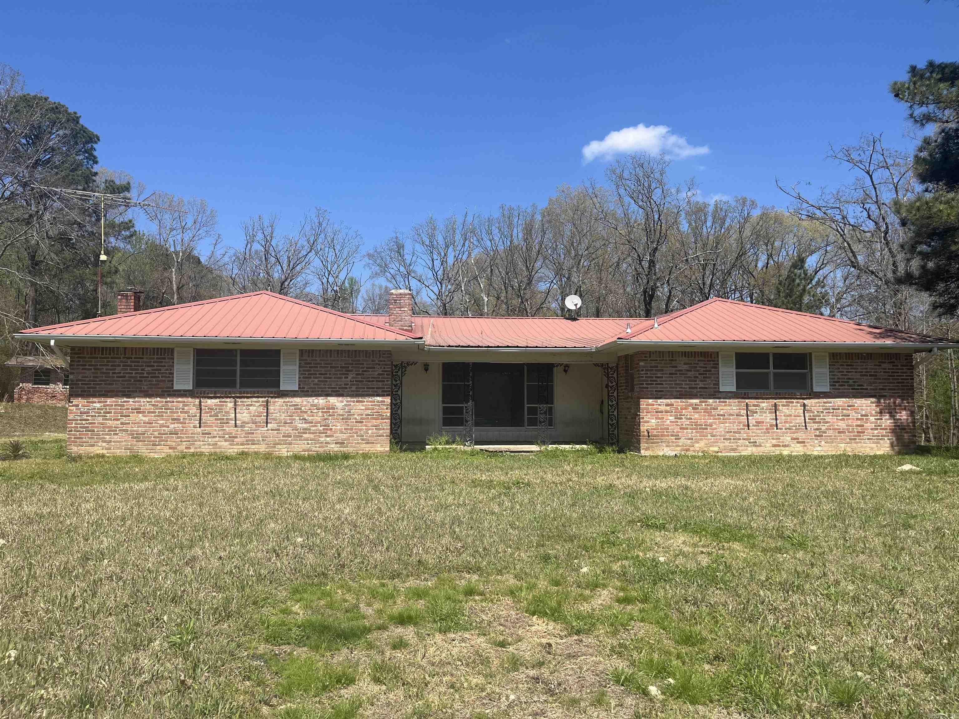 Opportunity awaits! Situated on approximately 5.3± acres, this 3-bedroom, 2-bath brick home offers 1,933± square feet of space ready for your vision and updates.  The home features a spacious layout, including a large laundry room and solid brick exterior, providing a great foundation for renovation. The property is located in Montgomery County within the Caddo Hills School District, offering a convenient location with room to spread out.  Please note: this property is in need of repairs and updates and is being sold as-is.   If you’re looking for a project property, investment opportunity, or a place to customize to your own style, this one is worth a look.