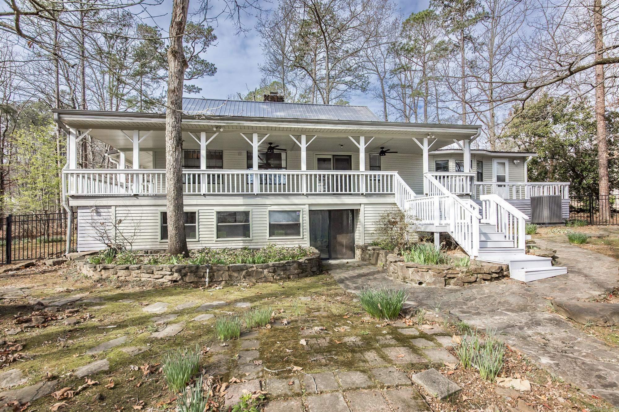 A peaceful retreat on the water's edge of Greers Ferry Lake surrounded by mature woods, soft moss and blooming gardens! Lakefront Home in the enchanted Mystic Isle Subdivision with easy walk to water, home has been completely renovated with updated kitchen and bathrooms. The generously proportioned interior flows effortlessly from the open-plan living space to the private rear patio perfect for family gatherings! All of this situated in a convenient, friendly neighborhood. Call today to see this lovely property!
