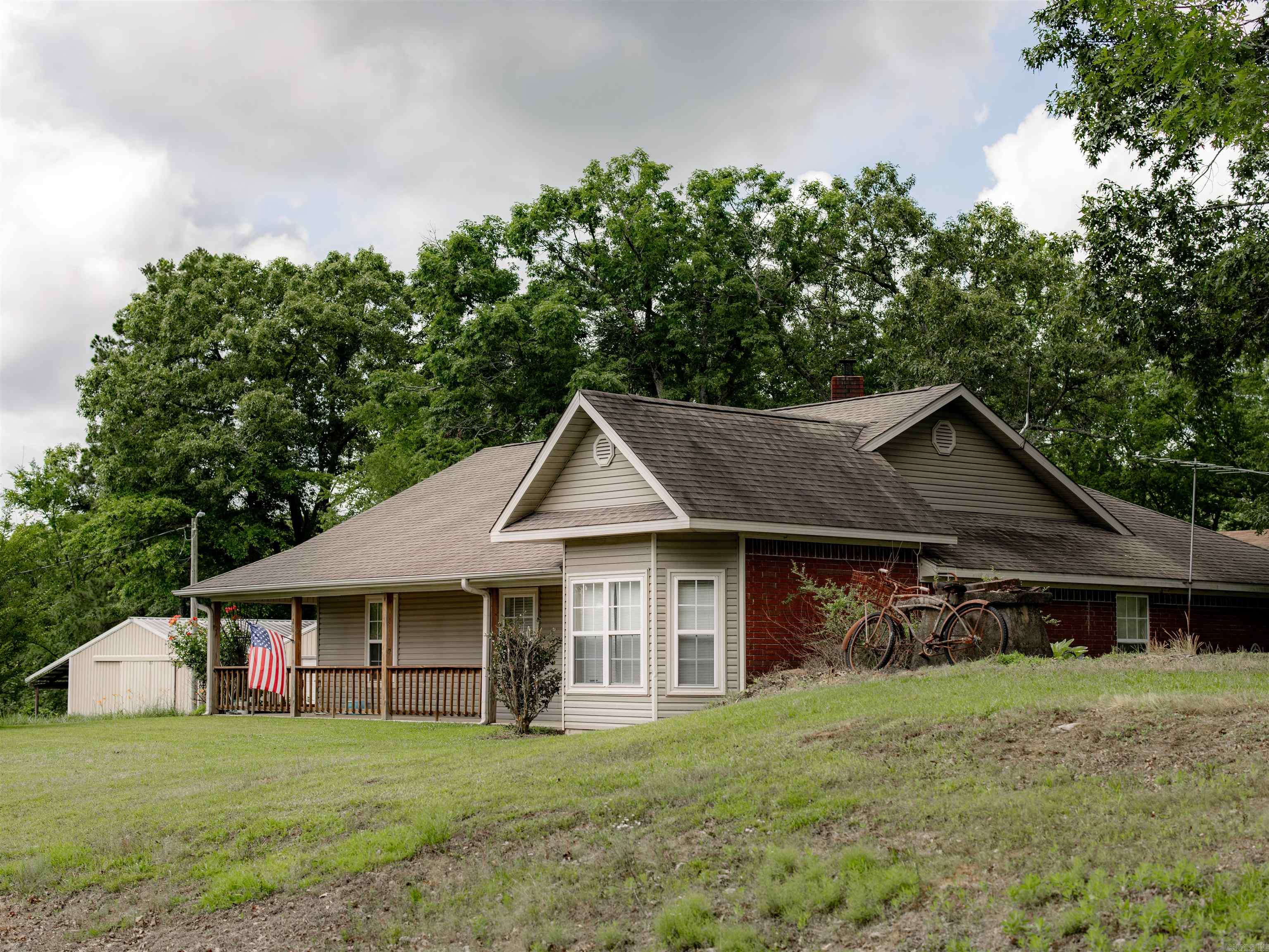 This beautiful 3-bedroom, 2-bathroom home, located just minutes from Lake DeGray, offers the perfect blend of peaceful country living and modern convenience.  Inside, you will find hardwood floors, spacious bathrooms and bedrooms, a cozy wood-burning stove setting on a brick fireplace and a nice laundry room.  The cozy enclosed back porch has entrances into the dining room and the laundry room! All the kitchen appliances convey with the home. Outside, the property features an additional 12 X 24 cabin that could easily be converted into a guest quarters or extra living space, two detach metal shop/garage buildings offering plenty of storage and workspace.  (One is 24 X 30 and the other is 30 X 30.) Situated on 3.66 beautifully acres, this property provides both comfort and versatility for ones forever home or the summer lake home. Call today for a showing!