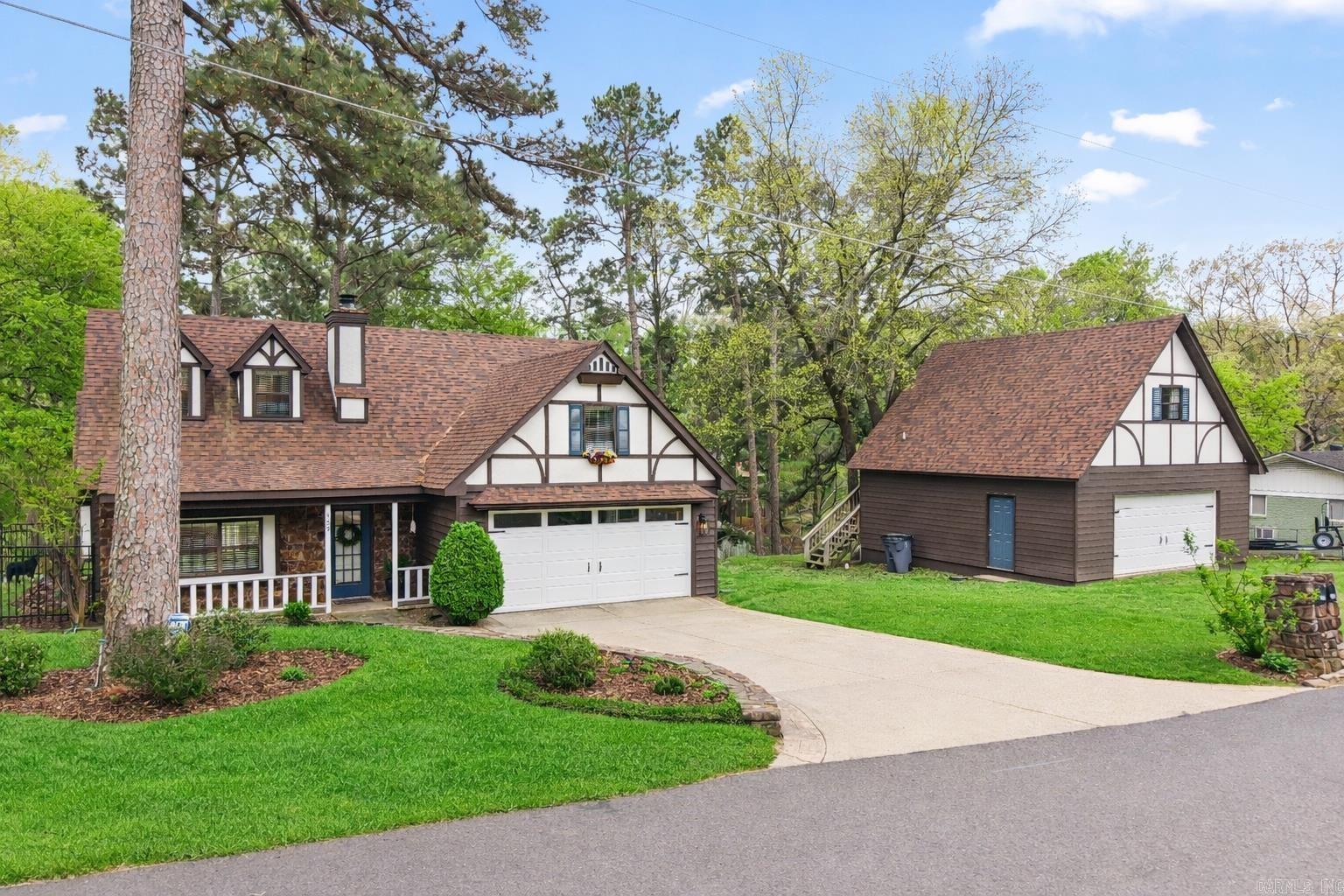 BACK ON MARKET - No fault of home! Previous buyer's financing fell through, giving you a second chance at this immaculate, totally updated English Tudor on Lake Hamilton. Location in the desirable 7 South area, you're minutes from Oaklawn Racing & Casino, downtown Hot Springs, and top hospitals. Nestled in a quiet cove, this home offers the perfect blend of serenity & convienence. Stunning landscaping & hardscaping. Enjoy lake life with a single boat dock, a large deck made for entertaining & a 2nd-level deck featuring a custom stone fire pit. RARE 4-car garage capacity! Includes an attached 2-car garage plus a detached 2-car garage with a private studio apartment/ADU above. Perfect for out of town guests, mother in law suite, or a long-term rental. There is also a 12x12 shed. Truly move in ready and well maintained with modern updates throughout. It is a MUST SEE! This is a RARE find! Don't miss your chance to own this Custom, One Owner Home! Comes with a Buyer's Home Warranty New Roof in 2023 (due to hail) Seller is a licensed real estate agent. Call 501-282-2216 for showing appt.