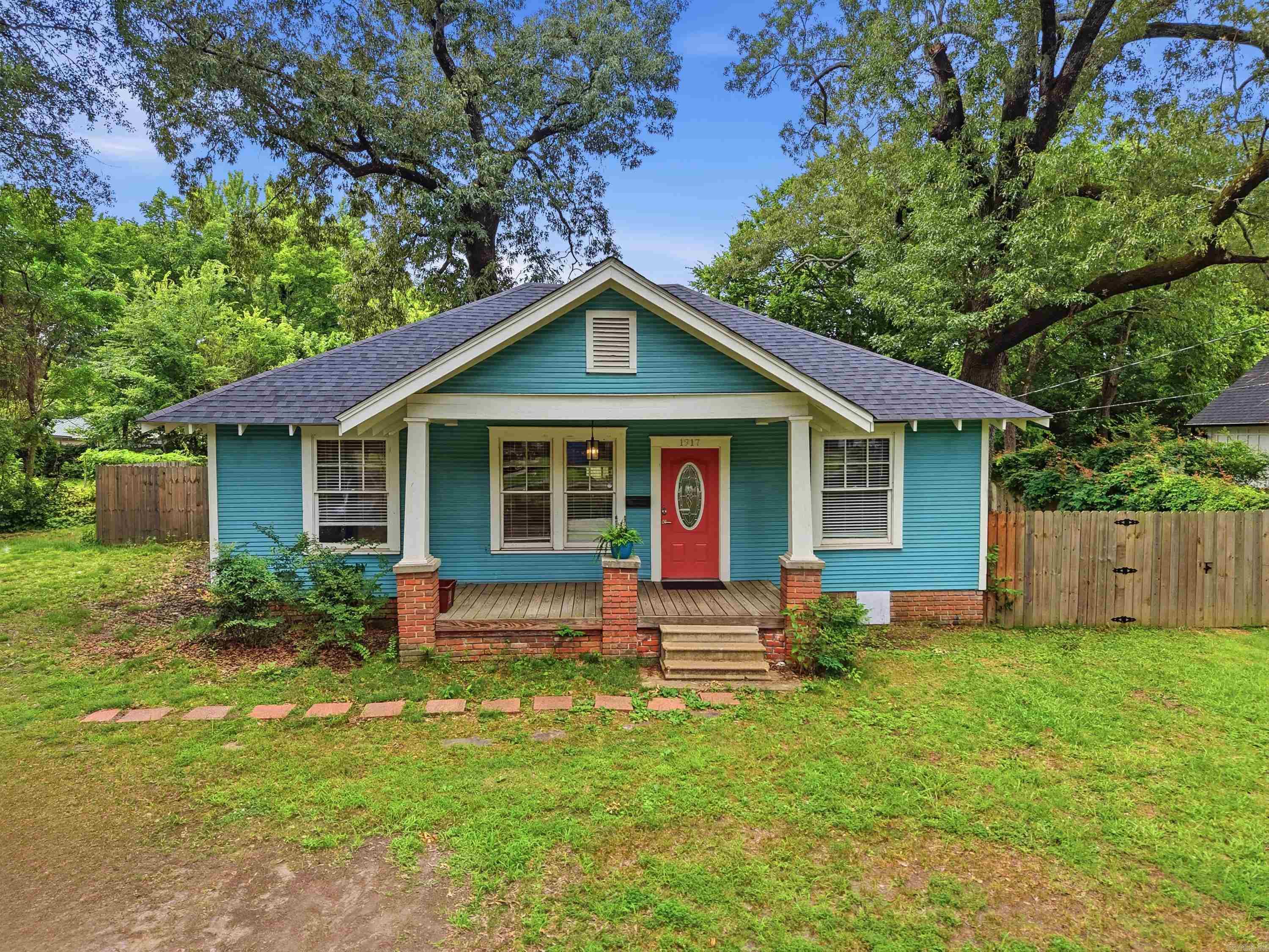 Step into the charm of Old Town Conway with this beautifully updated 3-bedroom, 2-bath bungalow situated on a generous 0.4-acre lot close to UCA! Blending historic character with modern upgrades, this home offers a warm and inviting atmosphere. The spacious kitchen has been thoughtfully renovated and features granite countertops, a breakfast bar, stainless steel appliances, tile backsplash, open shelving, and an oversized walk-in pantry. The open-concept layout flows seamlessly into the living area, creating an ideal space for gathering and entertaining while enjoying abundant natural light throughout. Privately positioned apart from the secondary bedrooms, the primary suite serves as a relaxing retreat complete with a walk-in closet and a stunning ensuite bath featuring a clawfoot soaking tub, walk-in shower, backlit mirror, and convenient laundry area. Two additional bedrooms offer ample closet space and share a well-appointed full bathroom. Outside, the expansive backyard provides endless possibilities for outdoor entertaining, gardening, play, or simply unwinding in your own private space.  Sellers hold active Arkansas Real Estate licenses.  Agents, see remarks.