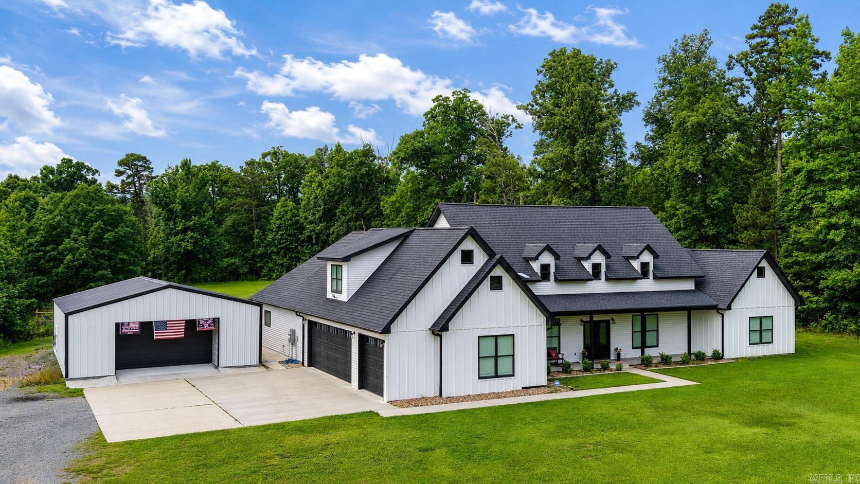 Experience luxury living and unmatched privacy in this stunning custom-built home situated on just over 4 beautiful acres in the White Hall School District. Designed with exceptional craftsmanship and modern elegance, this move-in-ready home offers 4 bedrooms, 3.5 baths, and a versatile upstairs theater room that can also serve as a 5th bedroom or office. The main level features all bedrooms, including an impressive primary suite with a spa-inspired bath showcasing double vanities, a designer tiled shower, soaking tub, LED dimmable mirrors, a concrete safe room, and an oversized walk-in closet. The open-concept living and kitchen area is highlighted by custom cabinetry, premium appliances, striking countertops, designer backsplash, and expansive windows with automatic blinds. Outdoor living is equally impressive with an extended patio ideal for entertaining, professional landscaping, mature trees, and a new privacy fence. Additional amenities include a 3-car garage, attic storage, brand-new septic system, and a 30x30 climate-controlled shop with mini-split. Don't miss your chance to own this stunning home outside city limits!