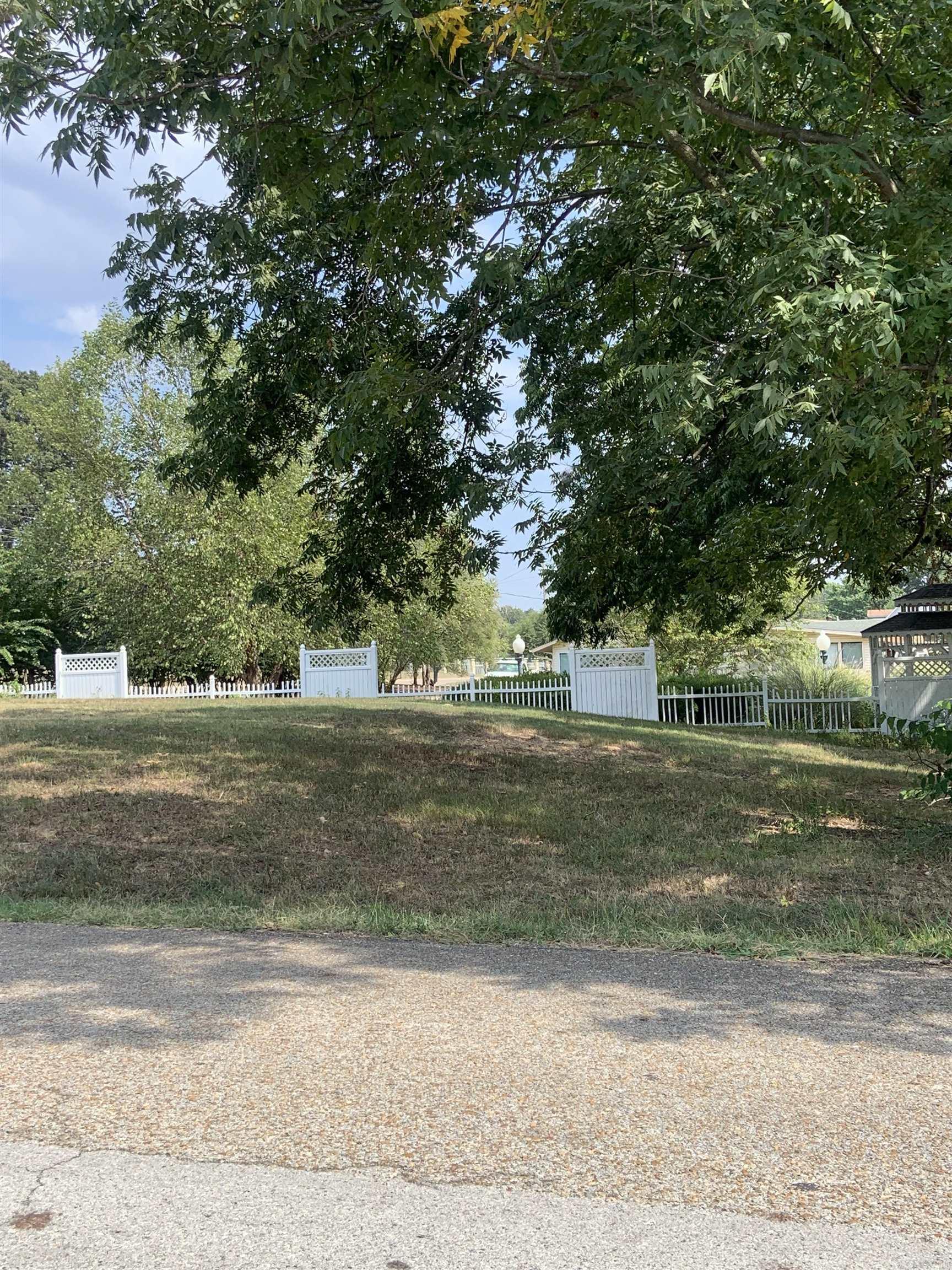 Nice  sloping lot on the Corner of Highway 412 West and Honeysuckle.  Zoned R-!   County Data reflects property to be .44 Acre.  No Property Disclosures. City utilities available, not on property