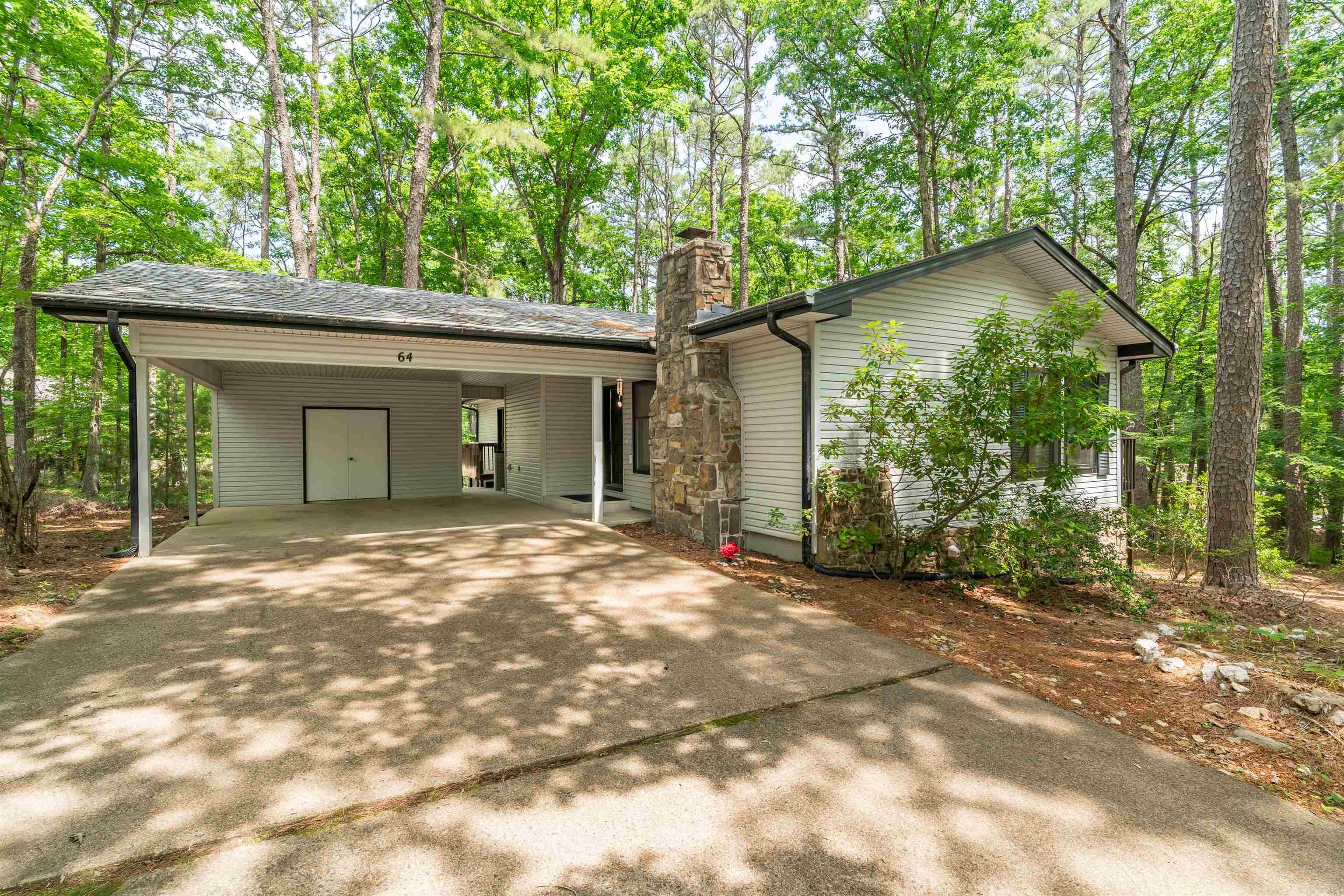 Great opportunity to get your foot in the door for your first home OR great investment opportunity. This home is waiting for you to put your finishing touches on it.  Relax on the large deck accessible from the living and the primary bedroom. Divided bedrooms, large living room with beautiful wooded view,  wood burning fireplace, Hollywood/Jack n Jill bath. Enclosed shop area, Encapsulated crawl space - 2023, Roof replaced 2024, HVAC - outside unit replaced 2021.