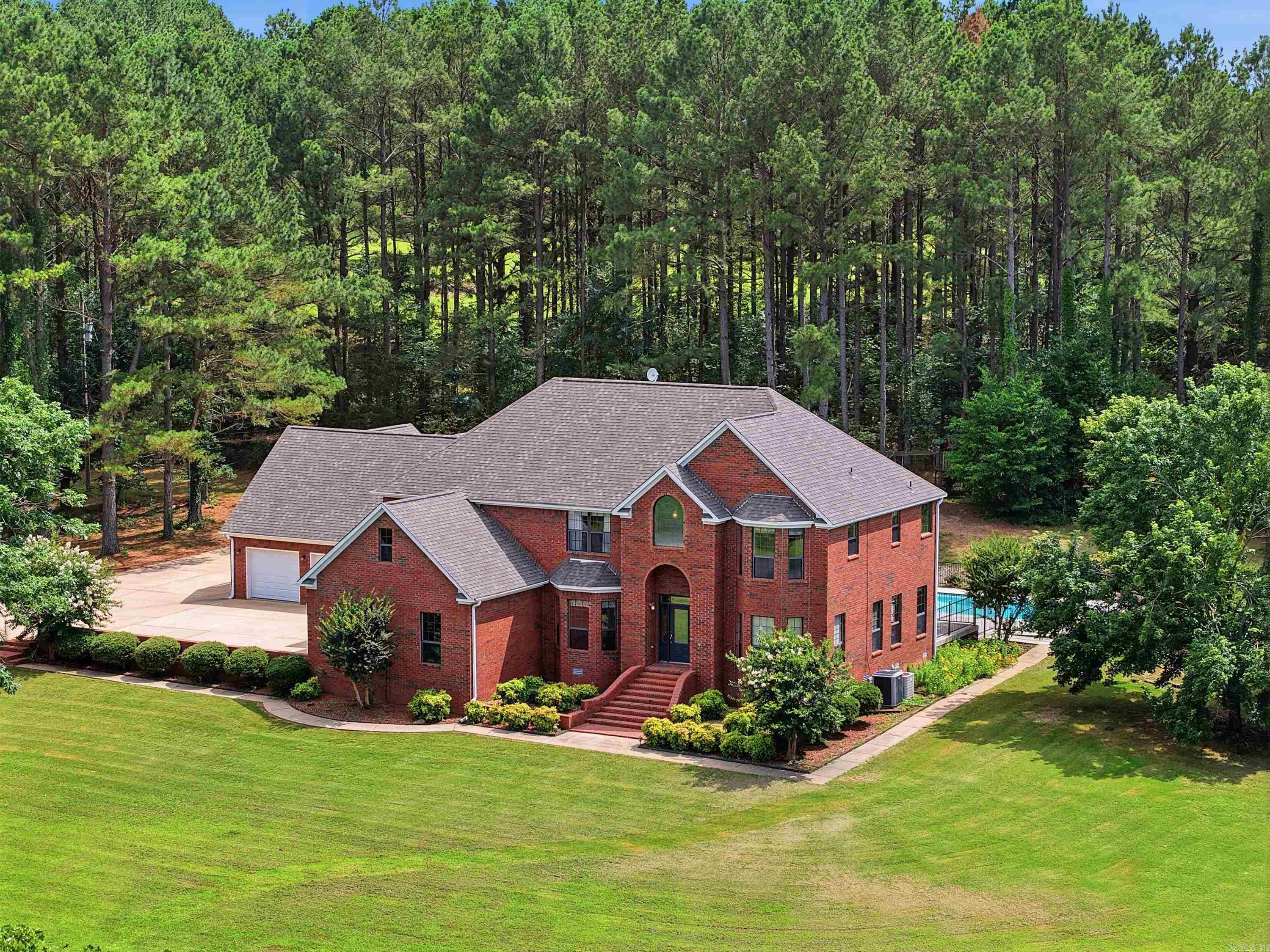 Welcome to 7 Night Owl Lane, a stunning two-story home situated on 3.37 acres in the Summer Hills Place subdivision. Offering 7 bedrooms, 4.5 bathrooms, and exceptional indoor and outdoor living spaces, this property provides the perfect combination of comfort, functionality, and room to grow. Designed with large families and entertaining in mind, the spacious primary suite features two attached bonus rooms-one ideal as a sunroom or office and the other offering flexible space with a large closet. Above the third and fourth garage bays, you’ll find a private apartment complete with a full kitchen, perfect for guests or a potential rental opportunity. Step outside to your own backyard retreat featuring a 16x36 inground pool, dedicated pool bathroom, large breezeway, and an impressive 12x40 covered patio with a grilling area. Situated on a corner lot, the property also boasts a large concrete driveway with lots of parking. Recent updates include a new roof and dishwasher in 2023, refreshed landscaping, new paint, resealed windows, enhanced French drains in 2024, concrete coating on the pool deck, breezeway, and patio in 2022. This exceptional property is ready to welcome you home!
