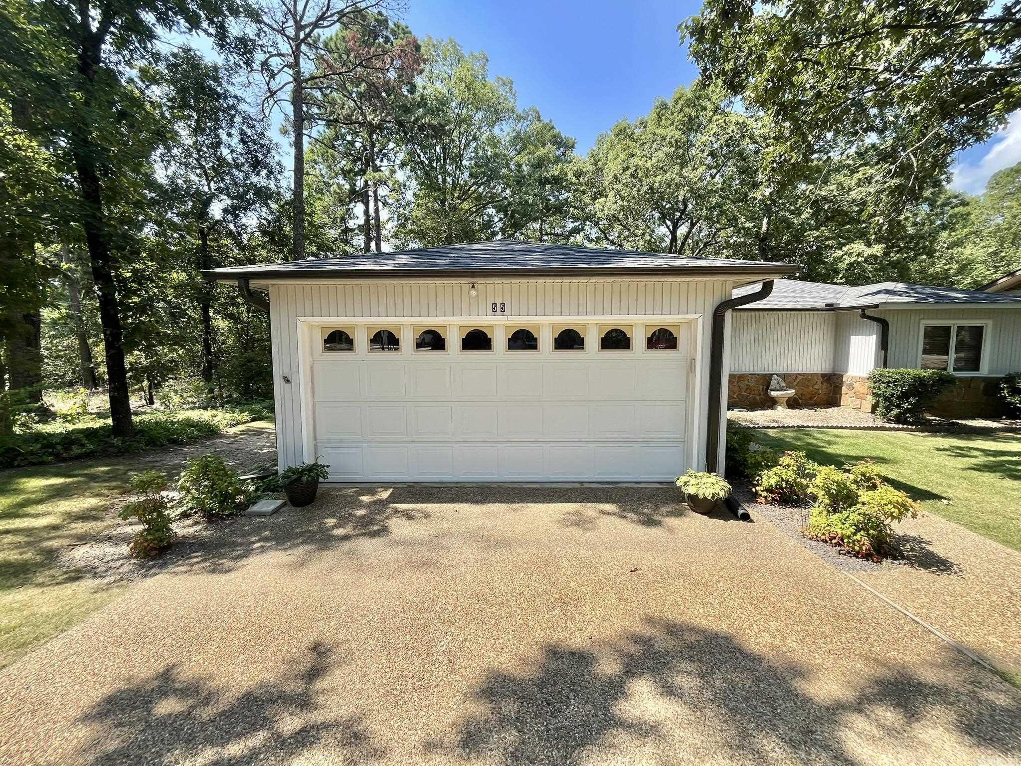Come see this beautiful home.  Whether it is your first home or your forever home this gem is amazing.  This 2-bedroom and 2-bathroom home is so beautiful and cozy.  New roof and leaf guards August 1, 2025, New HVAC 2023, New Garbage disposal 2025, New dishwasher 2026, Hot Water heater 2019, New floors and backsplash in kitchen.  Leaf filter warranty transfers to new owners.  Wood burning fireplace. Master bedroom with bath and second bedroom next to second bathroom. A large Arkansas room looking at the beautiful nature and this corner lot.  Three miles from the West Gate.  Large separate 10X16 workshop with electric power in back.  Two car Garage.  The landscaping on this is beautiful. POA has a $2,000.00 new member buy in fee due and collected at closing.