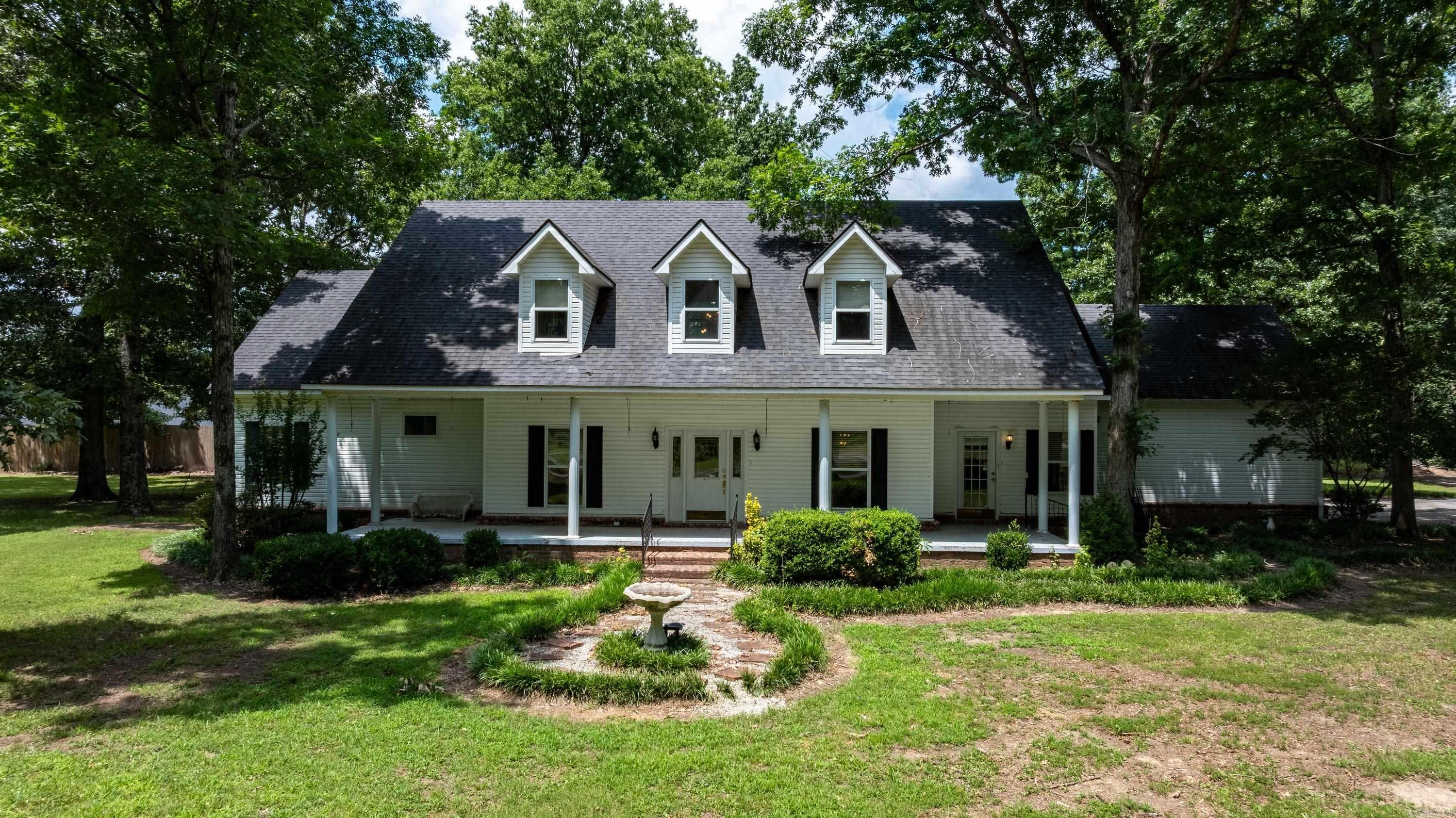 This stunning custom-built farmhouse on 2.15± acres, where country charm meets modern comfort just minutes from NEA Baptist Memorial Hospital, shopping, and dining.  A winding circle drive leads to a barn, workshop, detached 2-car garage, equipment sheds, garden area, and multiple outbuildings. Inside, you'll find soaring ceilings, a grand staircase, fireplace, built-ins, and a wall of windows overlooking the backyard. The main level features new luxury vinyl plank flooring, while the upstairs offers brand-new carpet and padding. The spacious kitchen boasts abundant cabinetry, a gas cooktop, oversized vent hood, large pantry, and breakfast area. The main-level office could easily serve as a 4th bedroom. The private primary suite includes a sunroom, covered porch access, spa-like bath, and oversized walk-in closet with laundry. Upstairs features two large bedrooms, a full bath, and two floored walk-in attic storage areas. Offering 2,828± heated/cooled SF (over 4,100± SF under roof), an attached and detached garage, a 2,000± SF fenced backyard, privacy fencing, and a new upstairs HVAC just installed, this exceptional property is truly one of a kind. Agent owned