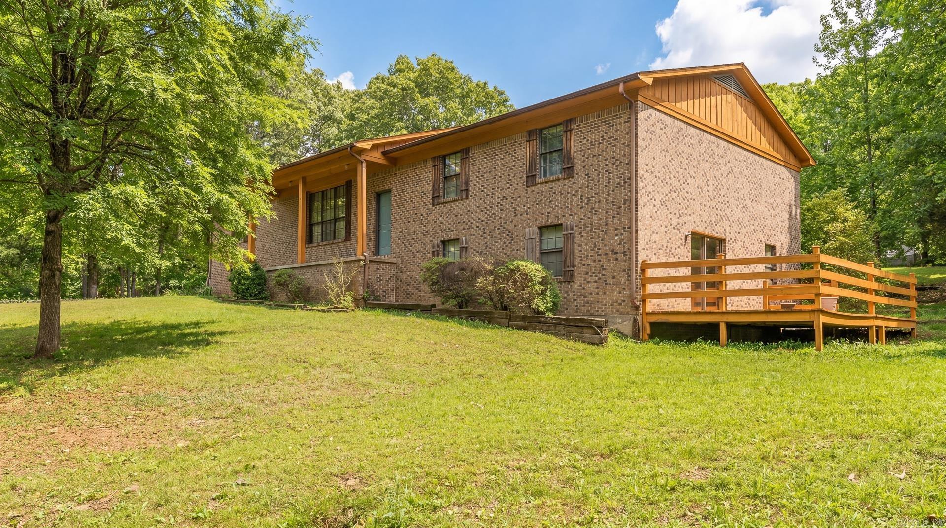 This gem of a home with a NEW ROOF is located on the westside of Paragould sitting on a beautiful 1.36 acre lot with mature trees.The main floor has a spacious living area with a woodburning fireplace and vaulted ceilings with wood beams. The kitchen has lots of cabinetry, plenty of counter space and open into the dining area as well as an office space/mudroom off the kitchen. The primary bedroom and bath,2 guest bedrooms and a guest bath is found on this level as well. Downstairs is another living space, bedroom,laundry and a flex room!