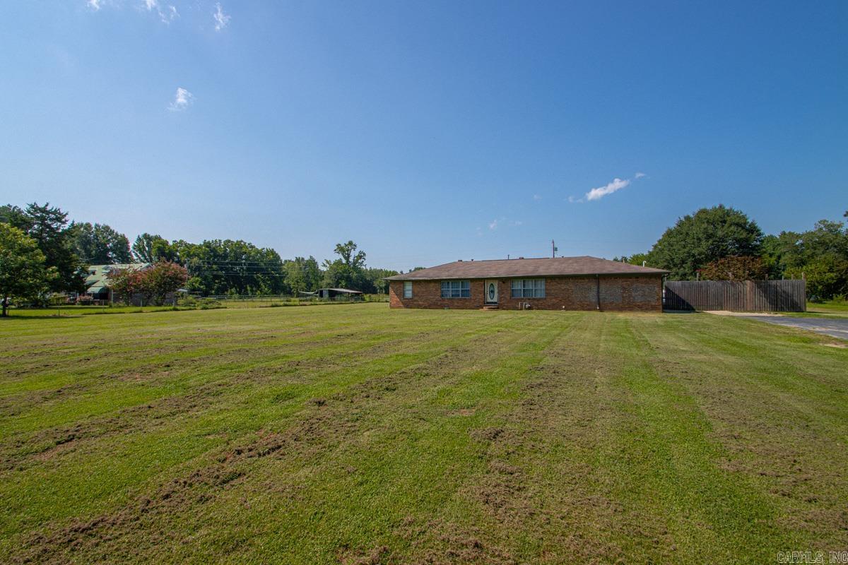 Enjoy country living with room to spread out on approximately 4.3 acres but still have the convenience of the city. This property offers 3 bedrooms and 2 baths with 2 bonus rooms and an extra large great room with a wood burning fireplace. The expansive yard features a salt water swimming pool and a shared pond at the back of the property making this property ideal for family gatherings, outdoor activities, and creating lasting memories.  The great room has an updated mini-split unit and recently added pine walls. The home has been updated with a new HVAC system with all new duct work, attic insulation, plumbing including tankless water heater & electrical. New appliances, lighting fixtures/fans have also been added and much more. The pool has been recently updated with a new liner and salt water pump. Hurry, this property won't last long! Property being sold as is. Square footage is approximate, please measure.