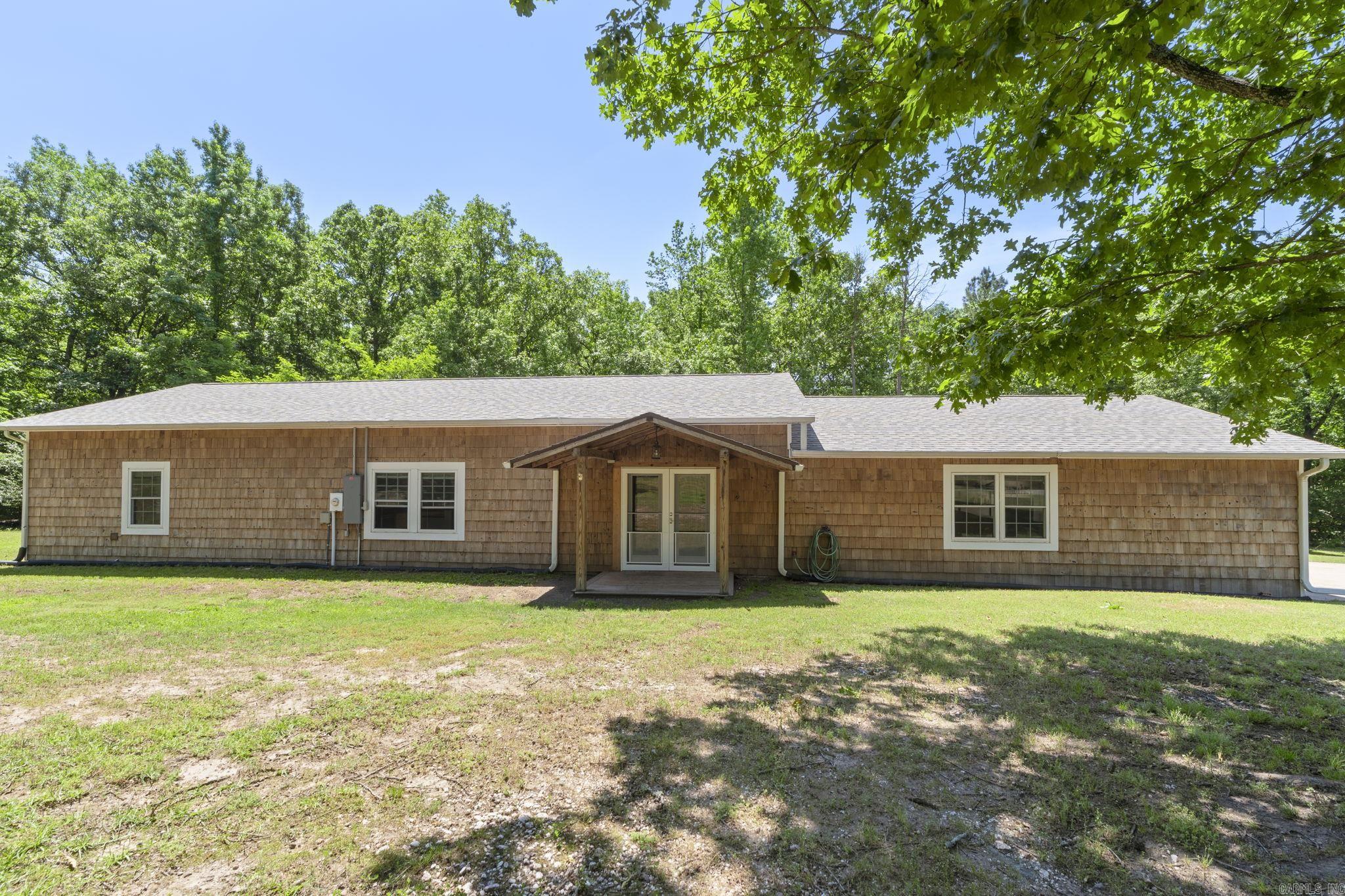 Enjoy the perfect blend of space, comfort, and country living with this 3-bedroom, 2-bath home on nearly 5 acres in the Bryant School District. The open floor plan seamlessly connects the living, dining, and kitchen areas—ideal for everyday living and entertaining. The spacious primary suite features a private en-suite bath and walk-in closet, while a secondary bedroom also offers its own en-suite and walk-in closet—perfect for guests or added privacy. A large garage provides ample space for vehicles, storage, or a workshop. Major updates include a new HVAC/heat pump (2021), roof (2024), electrical panel (2023), on-demand water heater (2021), new water lines (2021), and a 7,000-gallon septic system (2021). Additional highlights include a working well with Bison hand pump (2024), new spa (2024), and a termite inspection with transferable warranty completed 5/4/26. The property also features a second home site with all-new utilities and septic installed in 2021—ideal for future expansion, guest house, or rental potential. Enjoy peaceful country living with plenty of space to spread out. Buyers are encouraged to verify lot size using their own measurements.