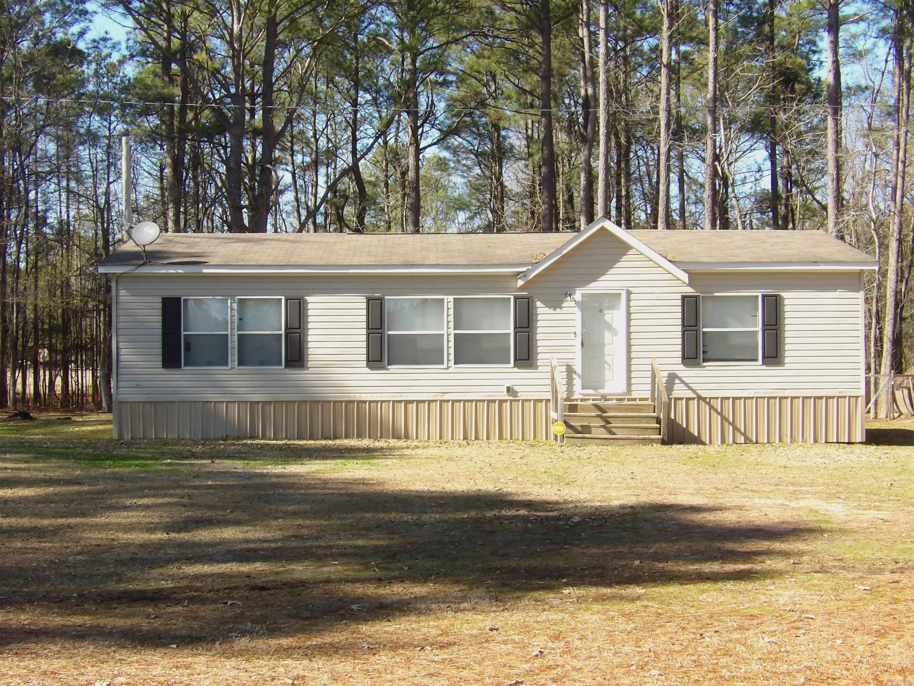Priced below appraisal and ready to sell, as-is!  This adorable 3 bedroom, 2 bath, 2014 Clayton Mobile Home has 1404sf and approximately 6.43 acres. Open concept living, dining and kitchen. Spacious kitchen with abundant cabinet space, dishwasher and hook-up for electric stove. A wonderful island with pendant lighting and storage provides additional counter space and is connected to the dining room with built-in cabinets. Primary bedroom and bath with soaking tub and separate shower and walk-in closet, 2 additional bedrooms share a hall bath in this split floorplan. A nice covered deck on back will provide great space to relax. A chicken coop and storage building are also included. There is a creek that runs to a pond. Great space for the kids to play and ride 4-wheelers and bicycles! Call today for an appointment to see this property.