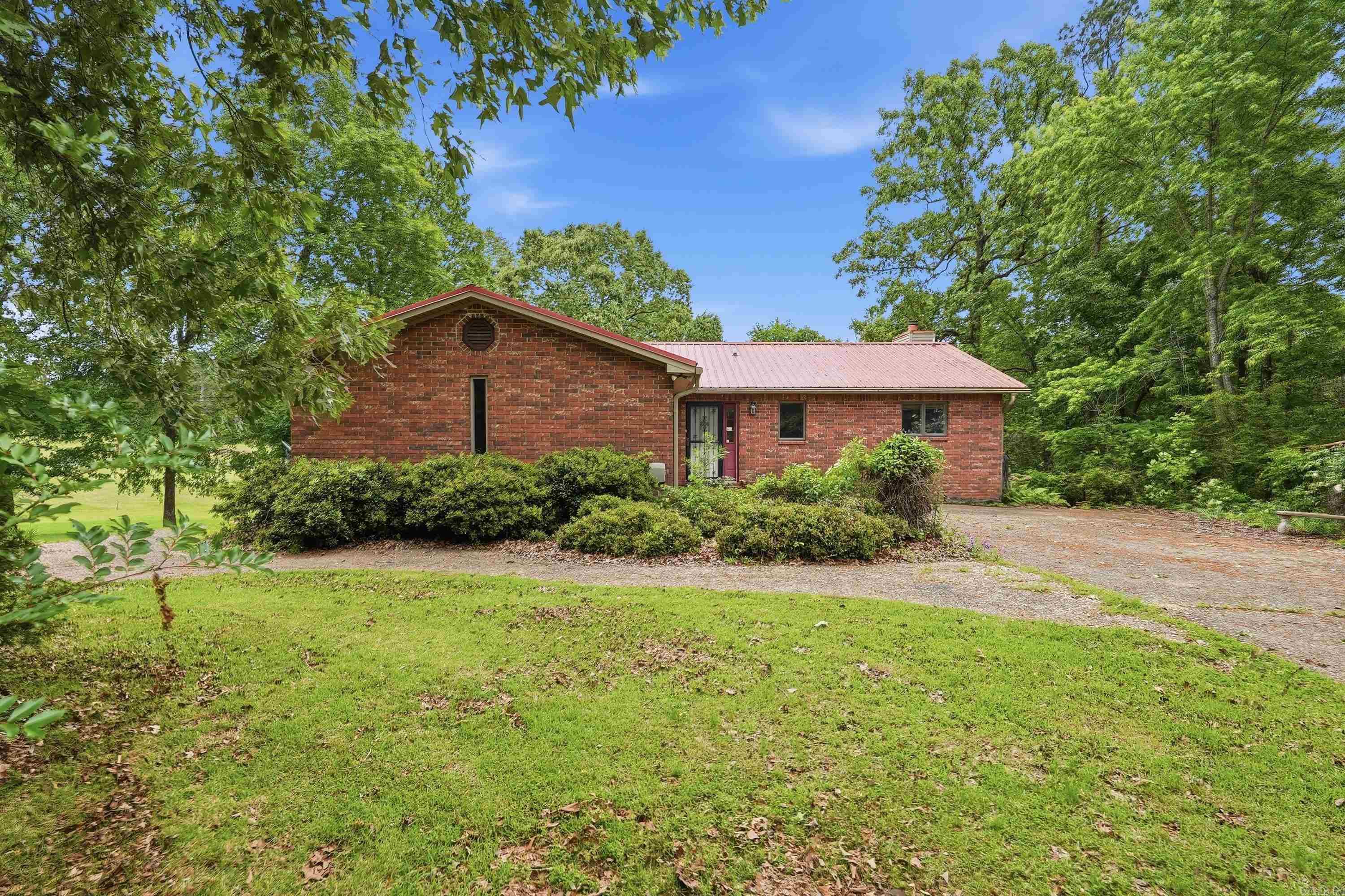 OPPORTUNITY KNOCKS ON THE GOLF COURSE! Bring your ideas & make this spacious 4-bedroom, 3-bath home your own while enjoying nearly an acre across two lots overlooking a PGA sanctioned golf course in one of Hot Springs most desirable areas. This amazing price reflects some updates needed but this property offers exceptional value w appr two lots, generous living space, & a versatile floor plan. Main level features two bedrooms, two bathrooms, a comfortable living area, a sunroom filled w natural light, & a deck overlooking the golf course. The lower level includes two additional bedrooms, a full bathroom, a spacious game room or flex space, & a walk out patio area that leads to the back yard.  Whether you're looking for a primary residence, a second home, or an investment opportunity, this property provides the space & setting to create something very special. Residents enjoy an opportunity thru monthly dues to access outstanding community amenities including clubhouse, swimming pool, pickleball courts & so much more. Minutes from Hot Springs lakes, hiking, & the excitement of Oaklawn Resort! If you've been searching for a golf course home w room to build equity this is it! see rmks
