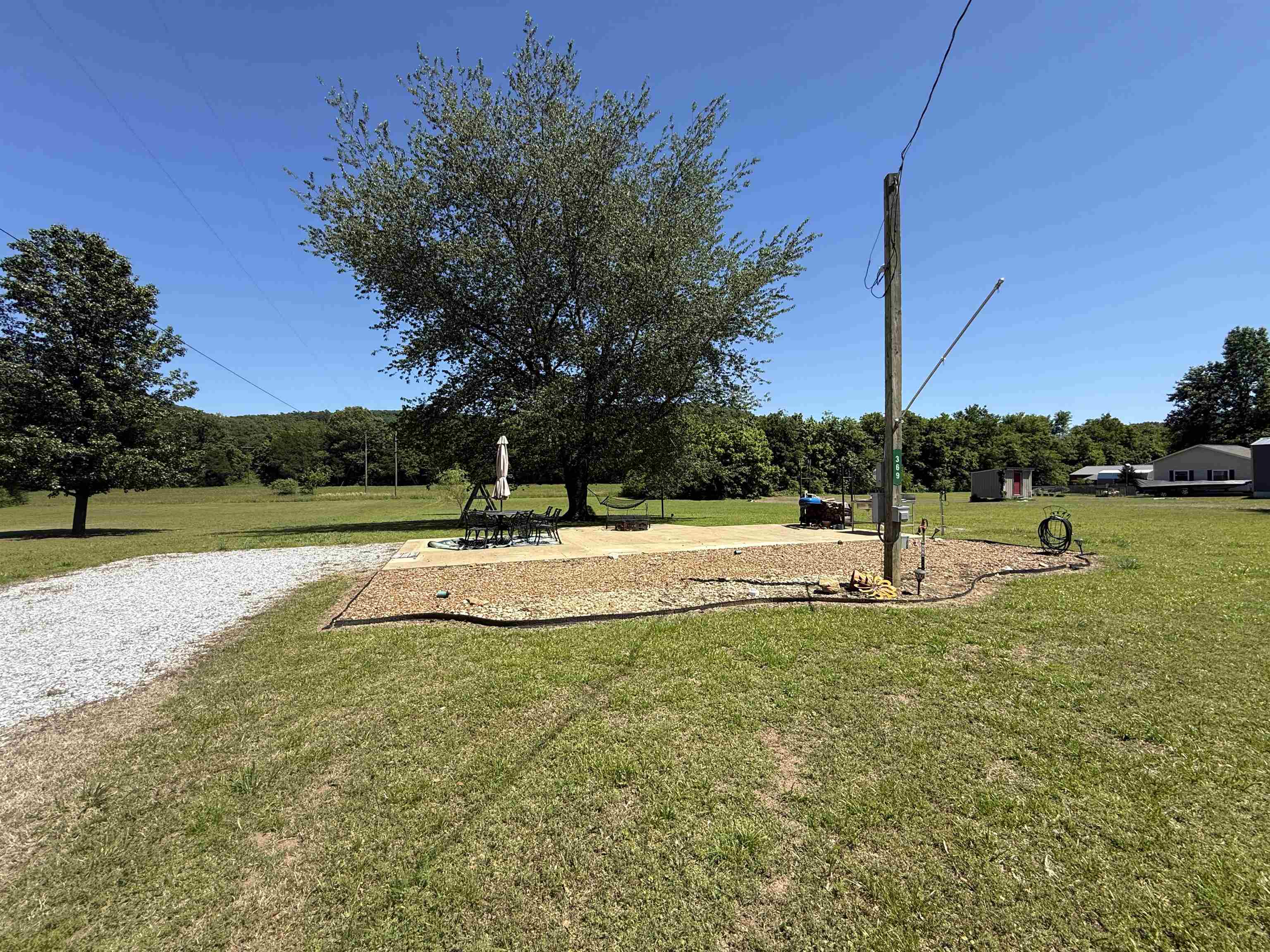 Located in the Sylamore area, this 15-acre property offers excellent access with frontage on North River View Lane and additional blacktop road frontage along the southern boundary. The land is level and usable, making it ideal for a variety of residential, recreational, or development opportunities. The property is already equipped with a well-prepared RV setup, including a concrete pad, electrical and water hookups, septic system, and an outdoor cooking area. It’s a great setup for trail riders or outdoor enthusiasts—bring your horses and enjoy turning them out on the open pasture while staying comfortably on-site. Conveniently located just across the river from Angler’s Restaurant at Slyamore and Allison, this property places you in the heart of one of North Central Arkansas’s most sought-after recreational areas. You’re only a short drive from Mountain View, the Ozark Folk Center, Blanchard Springs Caverns, and the Ozark National Forest. With level terrain and available utilities, this property presents excellent potential for development, all for only $190,000.