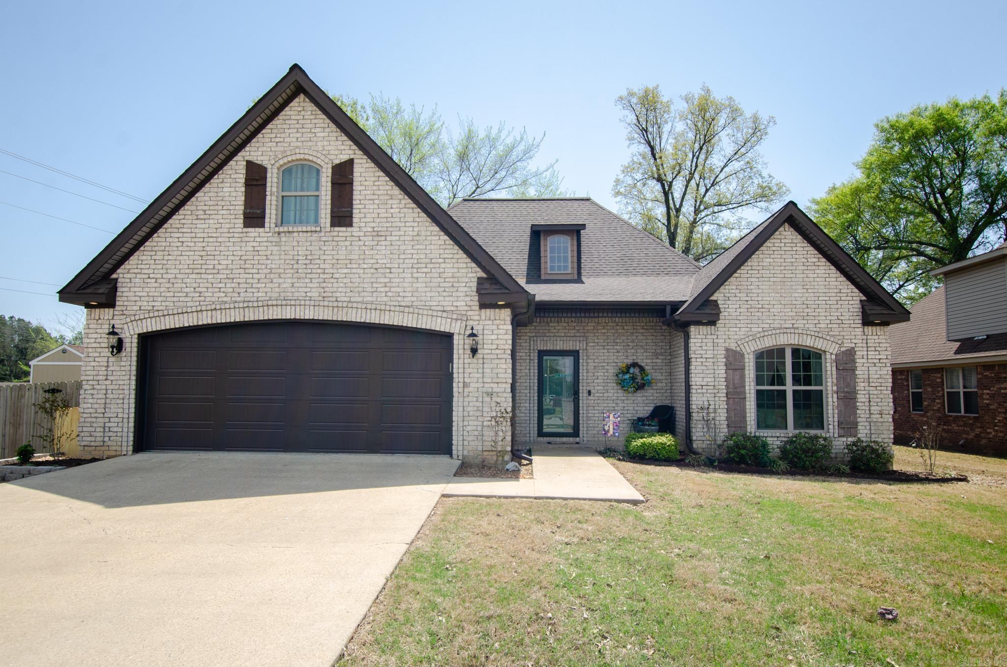 On a corner lot in Southbend, 5617 Viney Creek Lane offers comfort, space, and thoughtful design in every detail. The open living area features vaulted ceilings and a stone fireplace with a wood mantel, perfect for winding down or hosting friends. The kitchen stands out with beautiful wood cabinets, solid-surface countertops, a travertine backsplash, and a breakfast bar, plus new appliances added in 2021 and a generous pantry. Hardwood floors add warmth throughout, and with four bedrooms and three full baths, there's room to grow, work, or simply spread out. Step out back to a covered deck and fenced yard, ideal for quiet mornings or casual get-togethers. Well-kept and move-in-ready, this home feels just right.