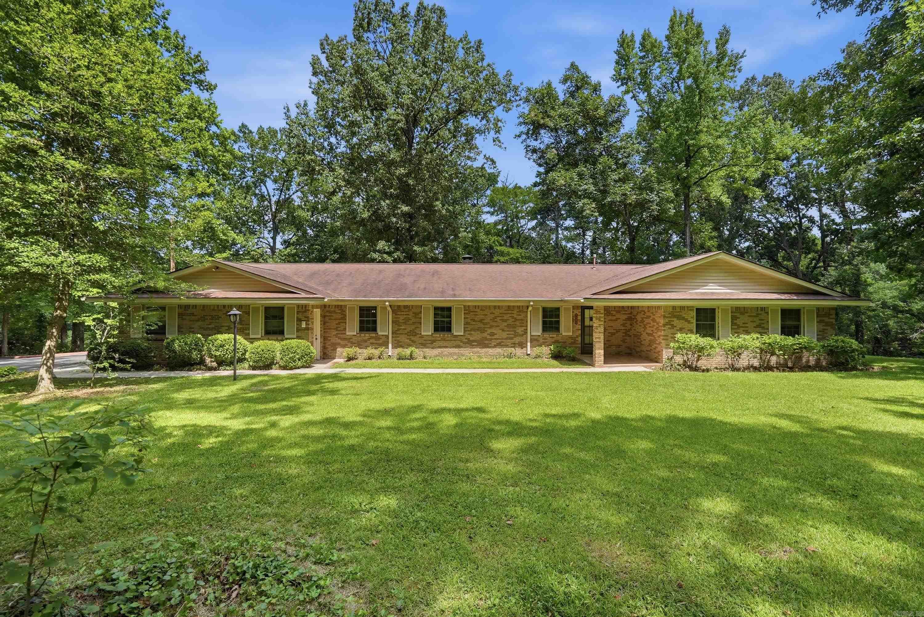 Escape the hustle without losing the convenience of city living. Nestled on a private 1.39-acre lot, this beautiful, all-brick home offers the perfect country feel just minutes from town.  Inside, you will find a spacious layout featuring two distinct living areas and a cozy wood-burning fireplace perfect for family gatherings. The kitchen comes equipped with a classic wall oven and flows into a formal dining room. Storage is a massive highlight here, boasting tons of storage throughout, a large laundry room, and an oversized garage with additional built-in storage space inside.  The outdoor setup is a true entertainer’s dream. Host weekend barbecues on the large covered back porch while enjoying the peace and privacy of your expansive acreage.  As an added bonus, the property includes a unique two-level storage shed equipped with electricity. The finished second level has been brilliantly utilized as a private workout room, but offers endless possibilities as a home office or hobby studio.  Priced below market value for an incredible value opportunity.