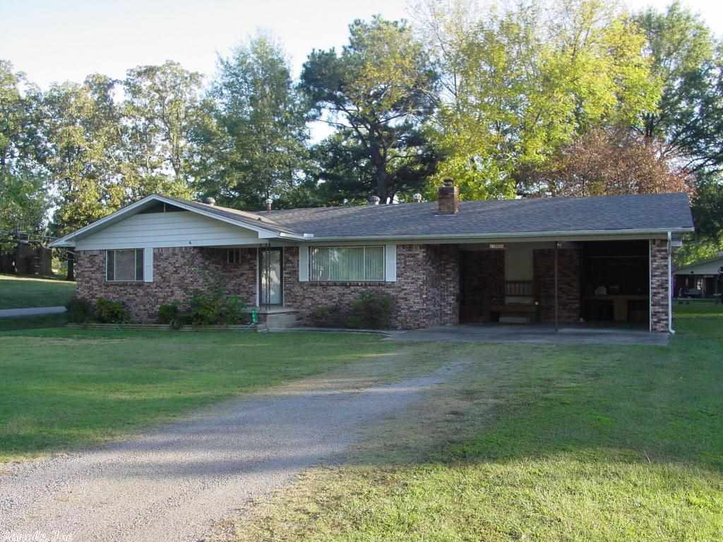 BRICK HOME This home may be in the center of town but it still has some privacy with the covered deck tucked away behind the landscaping. Features 3 BR 2 BA, new roof, corner lot, storage building and 2 car carport. Just bring your furniture and your kids and move right into this home in a very well established neighborhood.