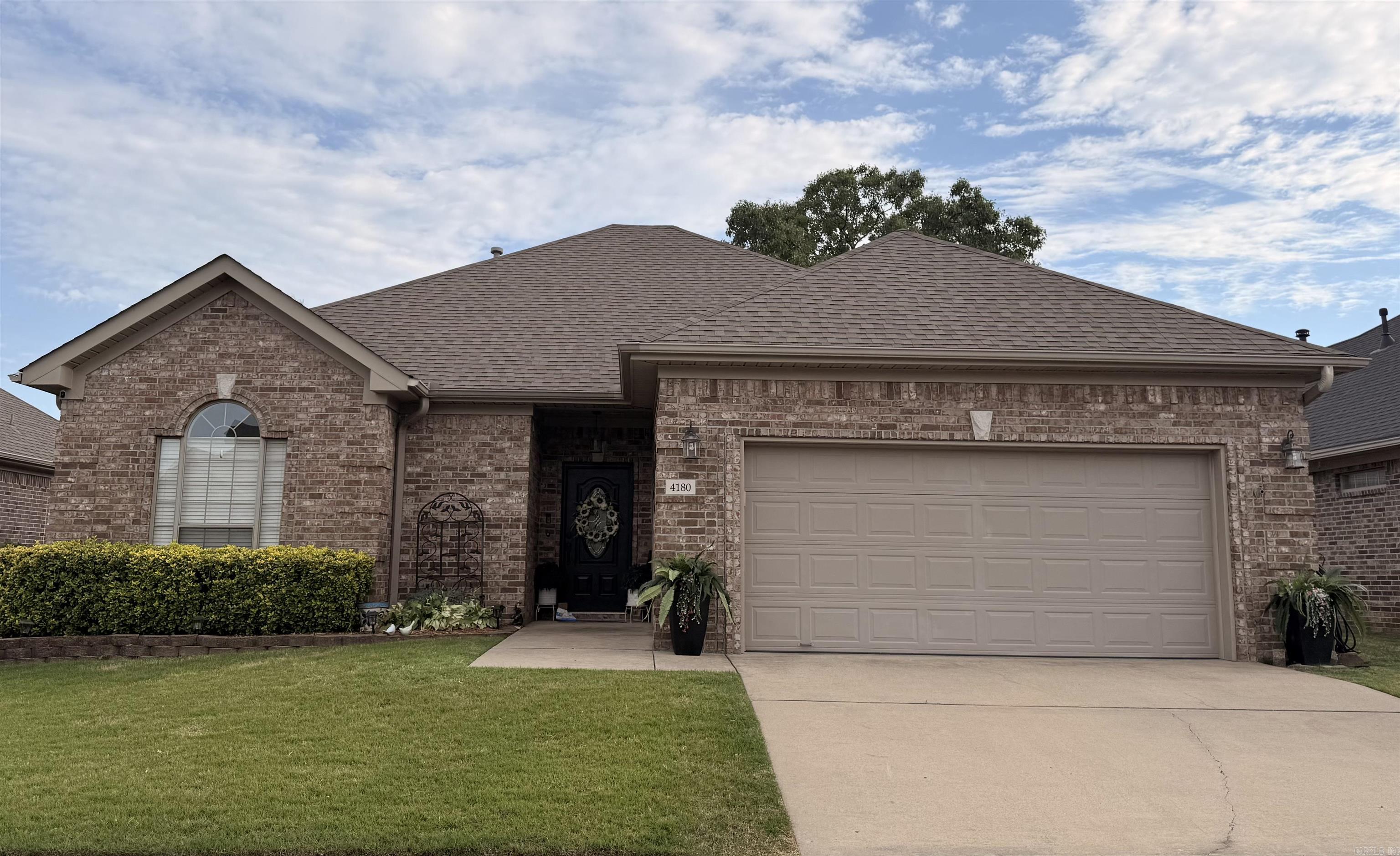 Fall in love with this stunning all-brick 3-bed, 2-bath home, beautifully appointed and impeccably maintained. Warm hardwood floors, installed in 2023, set the tone for the inviting interior. The kitchen features granite countertops installed in 2025, a pantry, abundant counter space, and quality finishes throughout. The Primary suite has tray ceiling, a walk-in shower, and a generous walk-in closet. Step outside, a peaceful outdoor sanctuary awaits with a large patio ideal for relaxation or stylish gatherings. The fully enclosed yard provides both privacy and an elevated sense of calm. Additional features include a fireplace, full guttering with leaf guards, and a 2 car garage. The association maintains the front lawn for effortless living. Roof was replaced in 2023 and bathroom was renovated in 2025. See showing remarks