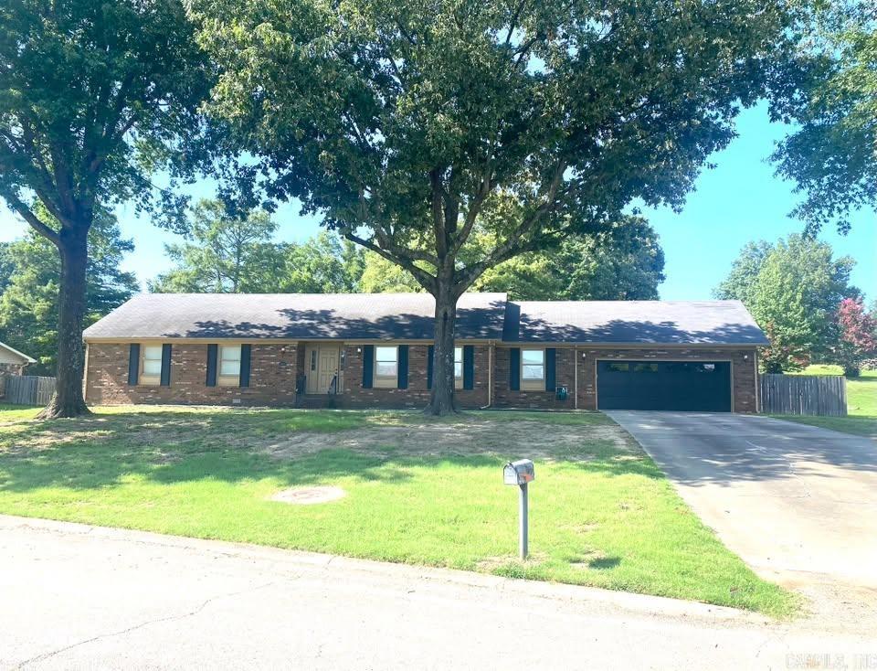 Beautifully renovated and move-in ready, this 3-bedroom, 2.5-bath home offers over 2,300 square feet of comfortable living on a spacious half-acre lot. Designed with both everyday living and entertaining in mind, the home features multiple living areas filled with natural light and surrounded by mature trees that create a peaceful setting.  The kitchen is the centerpiece of the home with quartz countertops, stainless steel appliances, a farmhouse sink, abundant cabinetry, and an open layout that flows into the main living spaces. The primary suite includes a walk-in closet, dual vanities, and a large tiled shower. Two additional bedrooms offer generous space and excellent storage.  Outside, you'll find plenty of room to enjoy the outdoors along with an oversized garage that's ideal for vehicles, storage, or hobbies. Combining modern updates, functional living spaces, and a beautiful setting, this home is ready for its next owner.