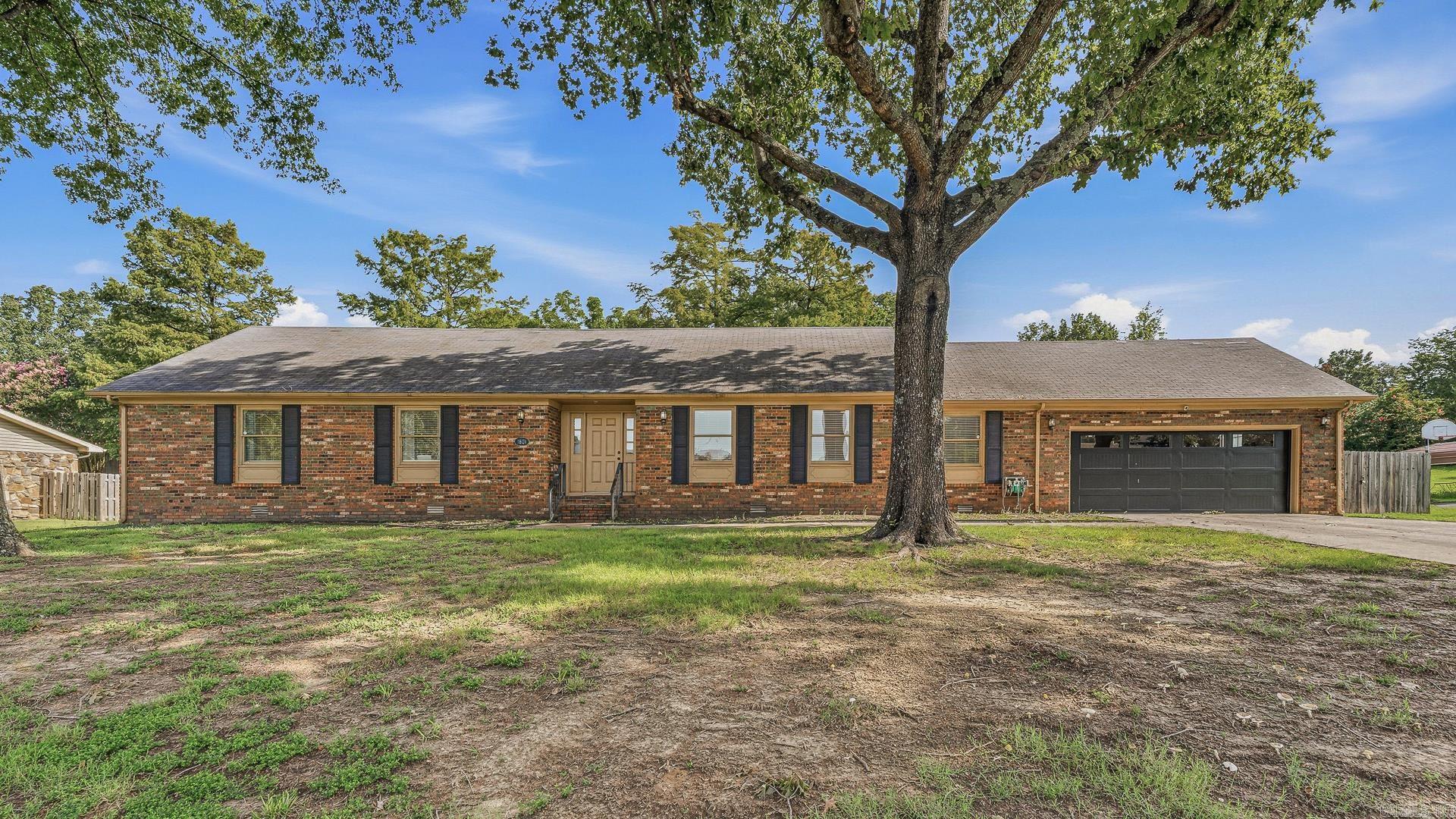 Beautifully renovated and move-in ready, this 3-bedroom, 2.5-bath home offers over 2,300 square feet of comfortable living on a spacious half-acre lot. Designed with both everyday living and entertaining in mind, the home features multiple living areas filled with natural light and surrounded by mature trees that create a peaceful setting.  The kitchen is the centerpiece of the home with quartz countertops, stainless steel appliances, a farmhouse sink, abundant cabinetry, and an open layout that flows into the main living spaces. The primary suite includes a walk-in closet, dual vanities, and a large tiled shower. Two additional bedrooms offer generous space and excellent storage.  Outside, you'll find plenty of room to enjoy the outdoors along with an oversized garage that's ideal for vehicles, storage, or hobbies. Combining modern updates, functional living spaces, and a beautiful setting, this home is ready for its next owner.