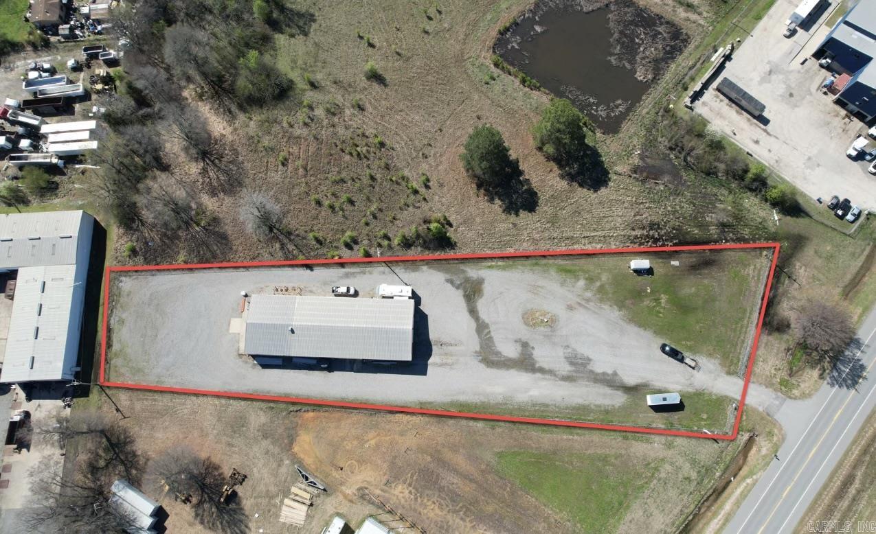 Situated within the city limits of Searcy and minutes from HWY 67/167, accessibility is an advantage. The office space is complete with a kitchen that is both heated and cooled, a full bathroom and setup for a washer and dryer. Additionally, the property boasts a heat-equipped back bay, making it suitable for various operations. The loading dock at the front facilitates easy handling of goods, while the packed gravel lot ensures durability and ease of access for vehicles. Security is paramount, with the entire property enclosed by a robust fence enhanced with razor wire. The wash bay located in bay number 3 is an excellent feature for businesses that require cleaning facilities. Furthermore, the property includes a septic separation system, promoting efficient waste management. The generous bay doors, measuring 23x12 feet, provide ample space for large equipment and vehicles. The inclusion of 3 phase power in the shop enhances its capability to support heavy-duty machinery, making this property a prime choice for businesses across various industries. Let's go check it out today! Seller may consider lease options or owner finance. Check with LA for details.