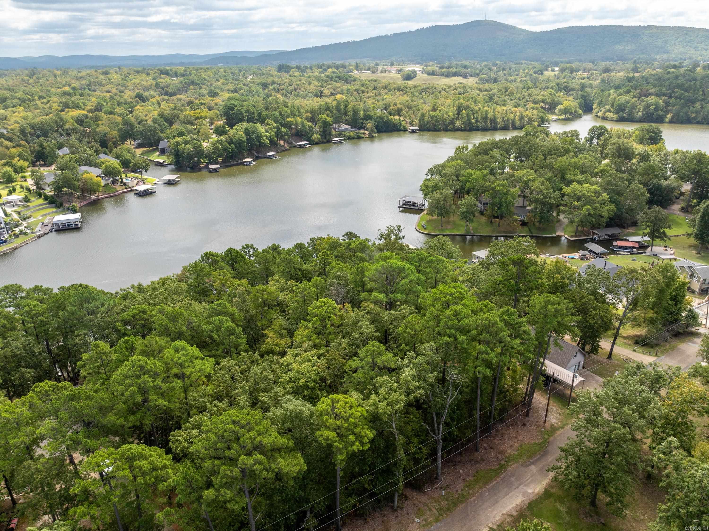 Ready to build your dream lakefront retreat? This beautiful piece of land offers 98 feet of shoreline on Lake Hamilton, complete with a boat dock with lift and PWC dock already in place. There's also an 8x12 storage building, convenient for storing all your water toys and gear. Whether you're looking for a weekend getaway or full-time lake living, this property is the ideal canvas to create your own waterfront escape.