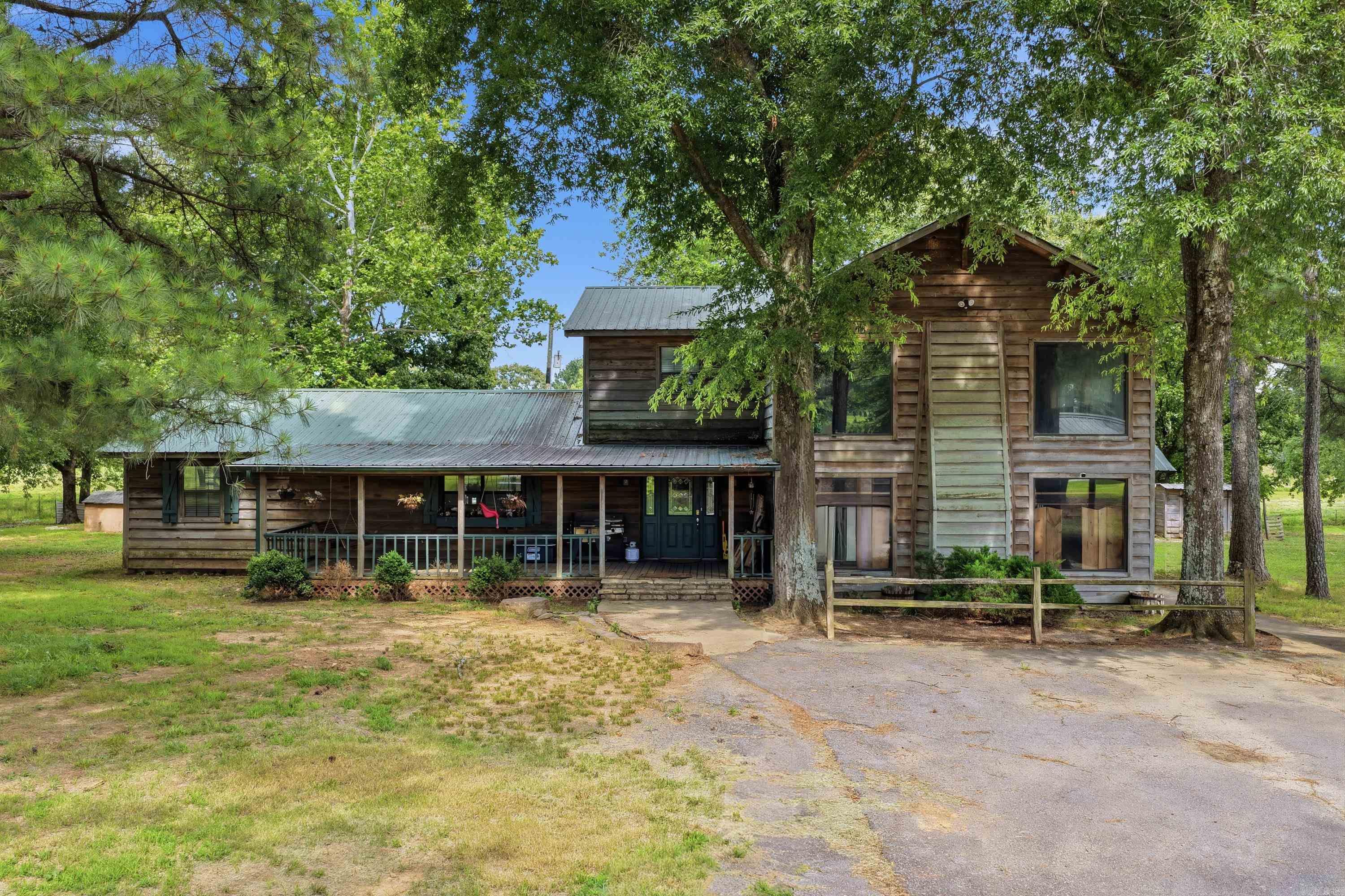 Enjoy peaceful country living on approx. 6 beautiful acres. Home offers 3 bedrooms, 3 bath and a versatile office that could easily serve as a 4th bedroom.  The inviting front porch provides perfect place to relax & take in the surroundings with the breeze blowing through the trees. You can also enjoy the above ground pool for summer enjoyment.  Travelers there is an RV hookup.  Whether you're looking for space for family or simply a quieter lifestyle, this property offers the comfort of county living with plenty of room to make it your own. Don't miss the opportunity to enjoy acreage, flexibility and outdoor amenities all in one property.