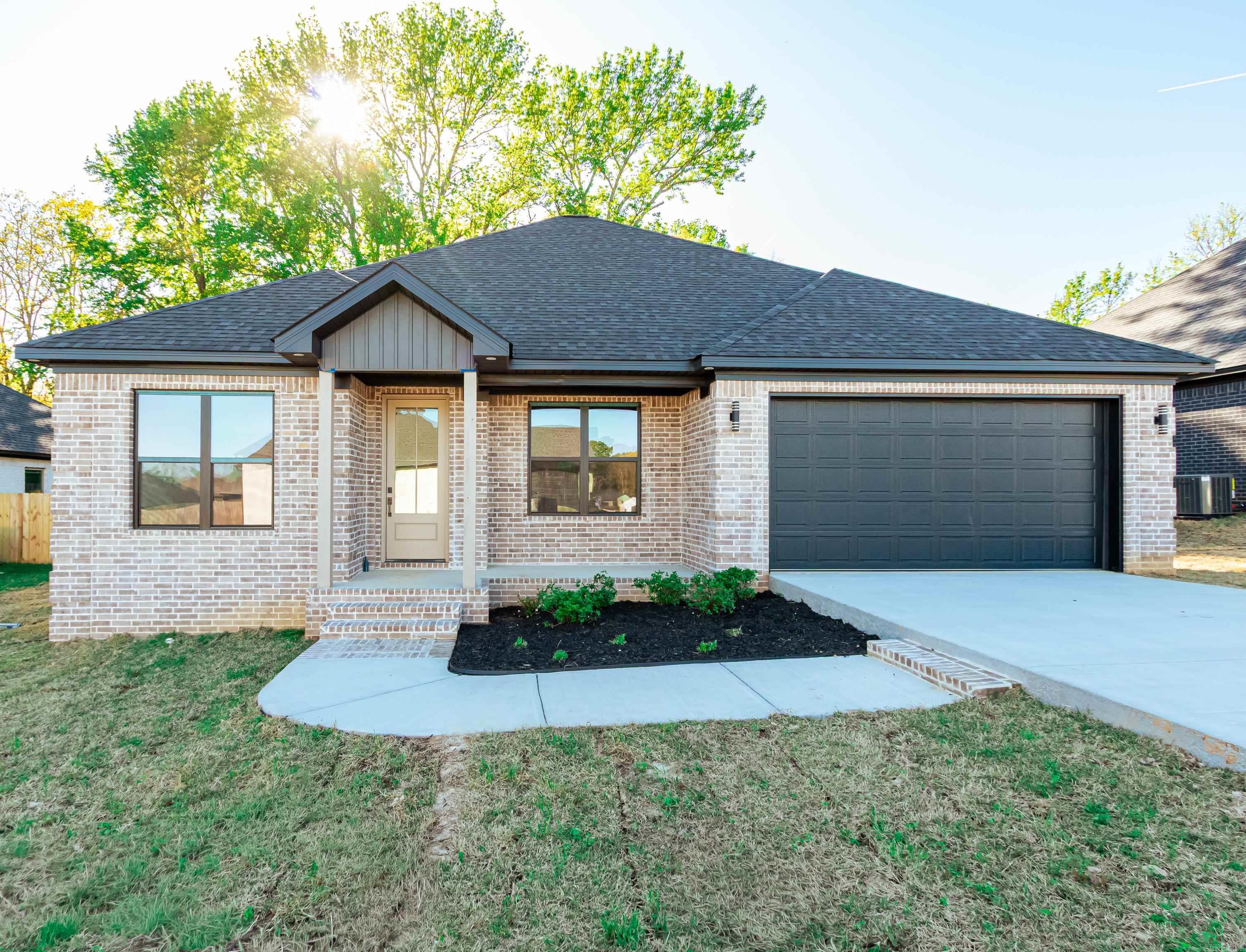 Jacksonville New Home! Enjoy this stunning new construction by Charles Anderson Homes! This residence boasts every luxury you could desire. The foyer opens up to a spacious Great Room with an inviting open floor plan and a stylish recessed electric fireplace. The kitchen and dining area showcase beautiful Quartz countertops, a range alcove with surround, and a large island that serves as additional dining space. Enjoy exquisite ceiling and cabinet fixtures throughout the home. The private Master Suite features double vanities, luxury vinyl flooring, a garden tub with upgraded tile surround, a custom tile shower, and two walk-in closets. On the opposite side, you'll find two bedrooms along with a guest bath and laundry room. Step outside to the covered porch, complete with an outdoor fireplace for cozy evenings. Plus, enjoy peace of mind with a One year Home Builder's Warranty!
