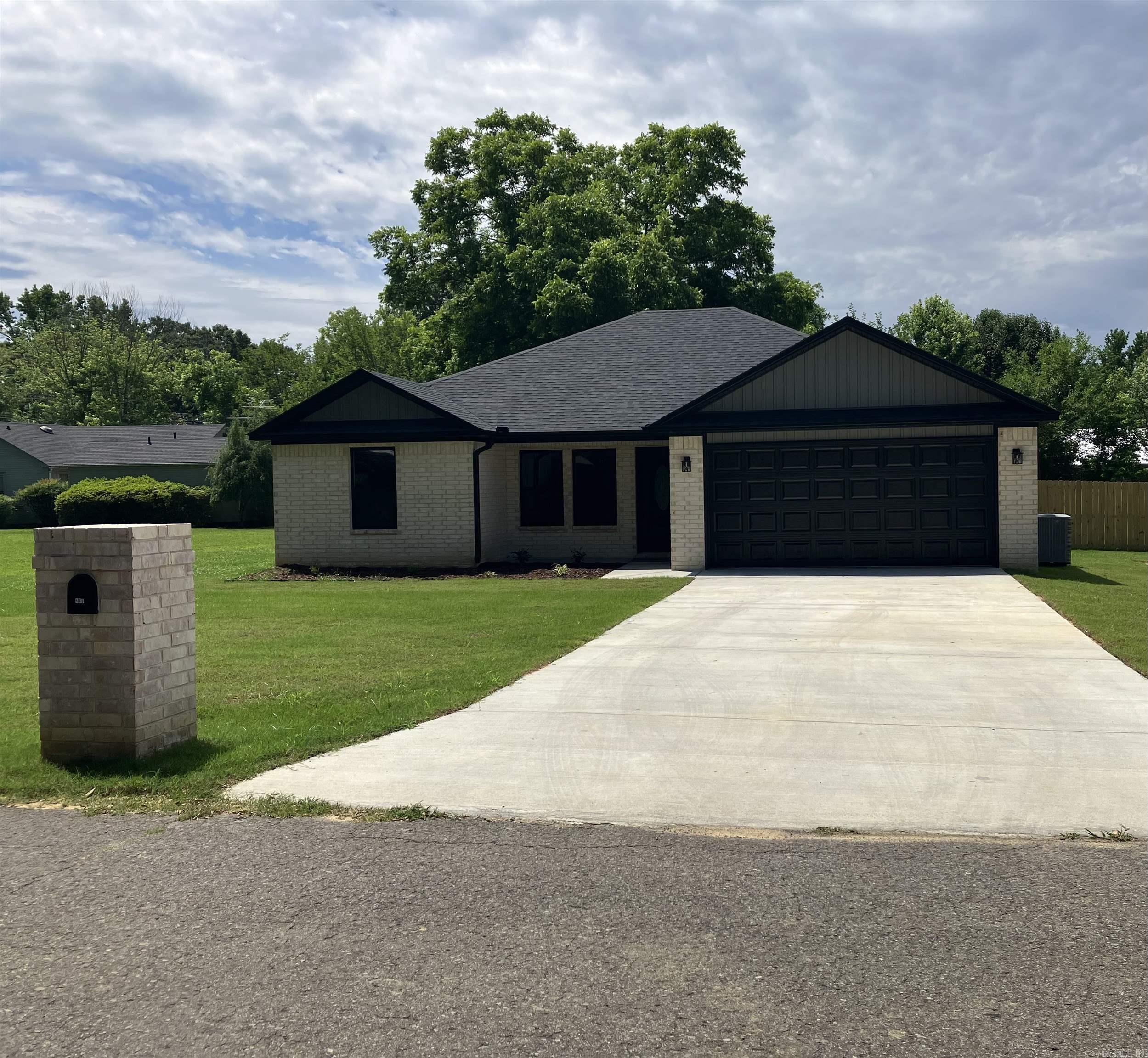 599 W Indiana, Beebe AR 72012 - Step into your dream home, where modern sophistication meets small-town charm! This stunning new brick construction is perfectly situated in a cozy neighborhood, offering the ideal blend of convenience and tranquility. You'll love being just minutes away from schools, shopping centers, and easy interstate access for seamless city travel—all while enjoying the peace of small-town living. Inside, this open-plan masterpiece features elegant crown molding enhancing its appeal. The master suite boasts a striking pan ceiling that elevates the room's grandeur, while the vaulted ceiling in the living area creates character. The kitchen shines with granite countertops and sleek cabinetry, offering a sophisticated hub for family gatherings.  Unwind in the luxurious master suite, where modern comfort meets indulgence. Enjoy the marble-accented walk-in rain-head shower, or relax in the freestanding tub for ultimate tranquility. This home is thoughtfully designed with you in mind. Covered porch and fenced backyard. Schedule your showing today!