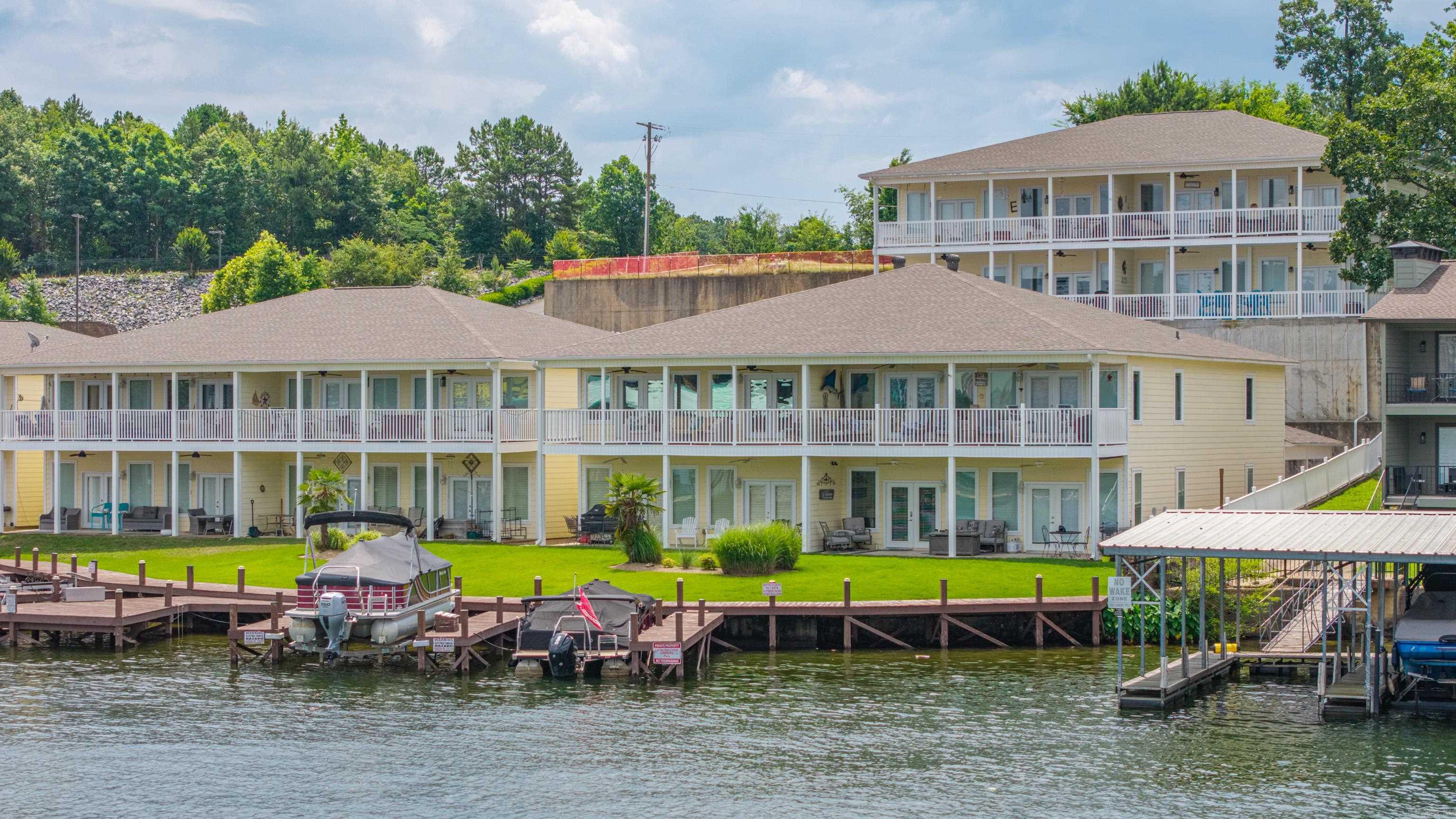 You'll find breathtaking main-channel views of Lake Hamilton from this beautifully maintained and fully furnished 2-bedroom, 2-bathlakefront condo. Situated in an upper-level unit, this home offers stunning water views and an open-concept design perfect for relaxing or entertaining. The spacious living and dining areas flow seamlessly into the kitchen, creating an inviting space for gathering with family and friends. Thoughtfully designed for privacy, the two bedrooms are located on opposite sides of the condo. The generous primary suite features direct access to the balcony, allowing you to enjoy peaceful lake views right from your bed. You'll also appreciate the large walk-in closet and spacious ensuite bath complete with a jetted soaking tub—perfect for unwinding after a day on the water. Step outside to the full-length balcony, an ideal setting for entertaining guests, enjoying your morning coffee, or taking in spectacular sunsets over the lake. Conveniently located just off Highway 7 South, you'll be minutes from shopping, dining, entertainment, medical facilities, and all the amenities Hot Springs has to offer. Cont'd in Inner Office Remarks...