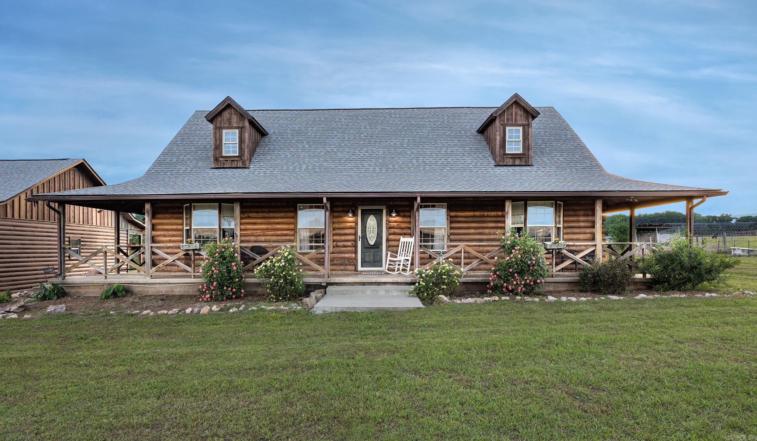 Step into a pastoral painting. Peaceful, 22.88 acre country estate includes a stocked fishing ponds, a horse and cow barn and approximately 20 acres of fenced pasture. Convenient to both Benton and Hot Springs, this custom built 4 bedroom 3 bath log home provides plenty of room for family and friends. Bright, remodeled kitchen, great room and upstairs loft are great for entertaining. Oversized 30x60x14 motorcoach shop (water/electric/sewer hookups) with loft storage and 3 car carport with large multipurpose room allow space for everyone’s work or hobbies. New HVAC system (2026) and roof (2024) offer peace of mind. View amazing sunrises and sunsets from the wraparound porch.