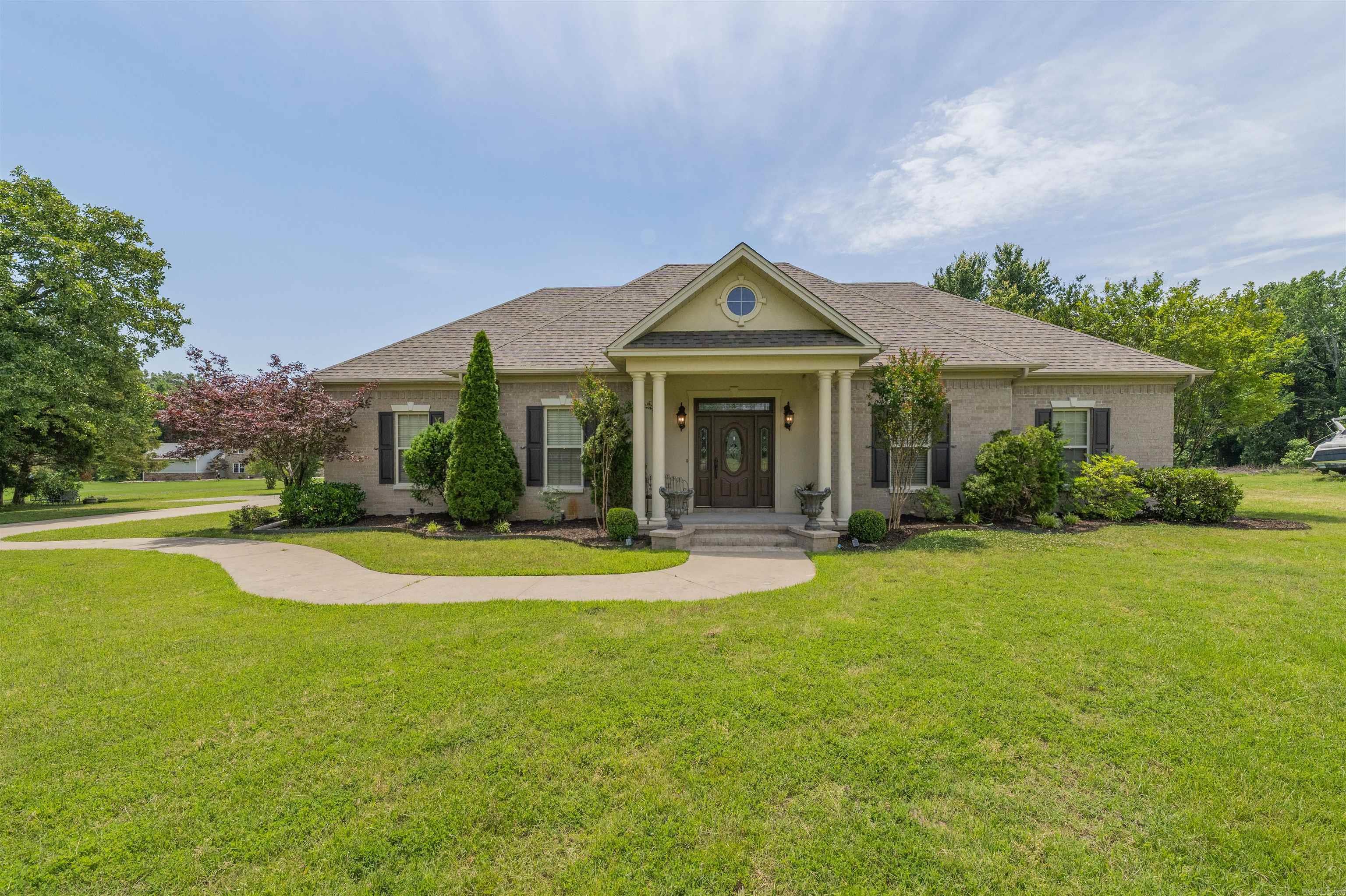Hard-to-find one-level brick home on 3 acres with a detached brick shop, 3-car garage, and extra parking pad. Right at 3,000 square feet with wood flooring, fresh paint, separate dining room, and an updated kitchen with refreshed countertops and hardware The primary suite offers a beautiful tiled walk-in shower, soaking tub, and large walk-in closet. French doors open to the 4th bedroom, giving the perfect office or flex space option. Geothermal system, sprinkler system, and built-in speakers throughout add comfort, efficiency, and convenience to this exceptionally well-kept property.