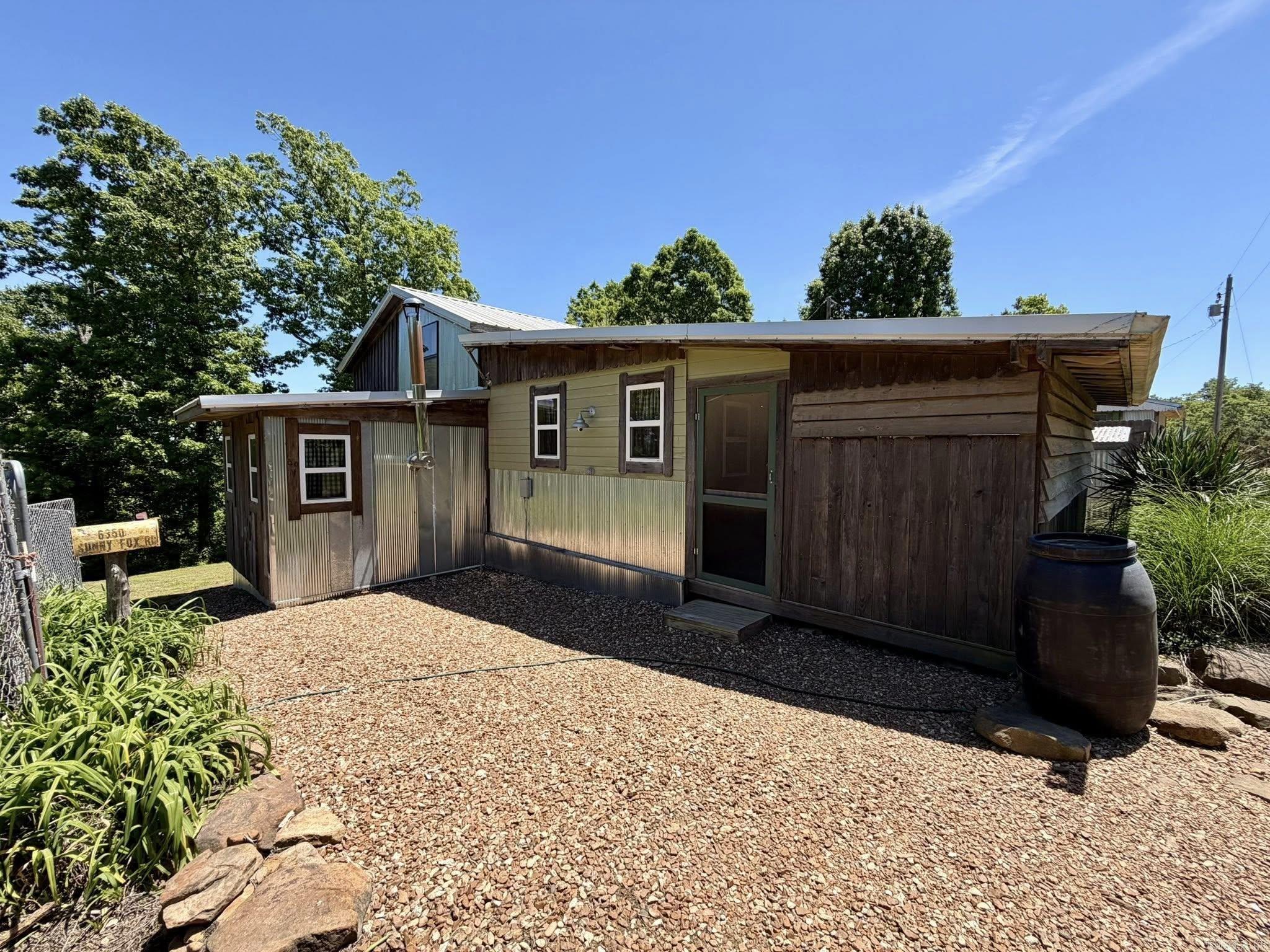 This is a beautiful property in the country just outside of Mountain View. It is listed as a 2-bed, 2-bath, However, in the upstairs area there is plenty of room for more bedrooms/sleeping space. It also includes a mother In-Law suite perfect for guests, an office, or workshop. The property has multiple out buildings. Some are for storage, some for firewood storage, a chicken coop, and an old home. The old house is falling down and does not hold much value, but some materials from it may be reusable. There is also a beautiful garden area that is fenced in, and has lots of varieties of flowers, plants, and fruit trees. The main house offers a new central heat and air system as well as a walk-in closet, gas and wood burning ranges, built-ins, office and storage space, and a separate laundry room. Just a short drive away from the town of Mountain View, and all the local amenities. Which included, restaurants, shopping, hiking trails, The White River, and The Ozark Folk Center State Park, and so much more. This is definitely a one-of-a-kind property and is a must see. Call today to set up an appointment.