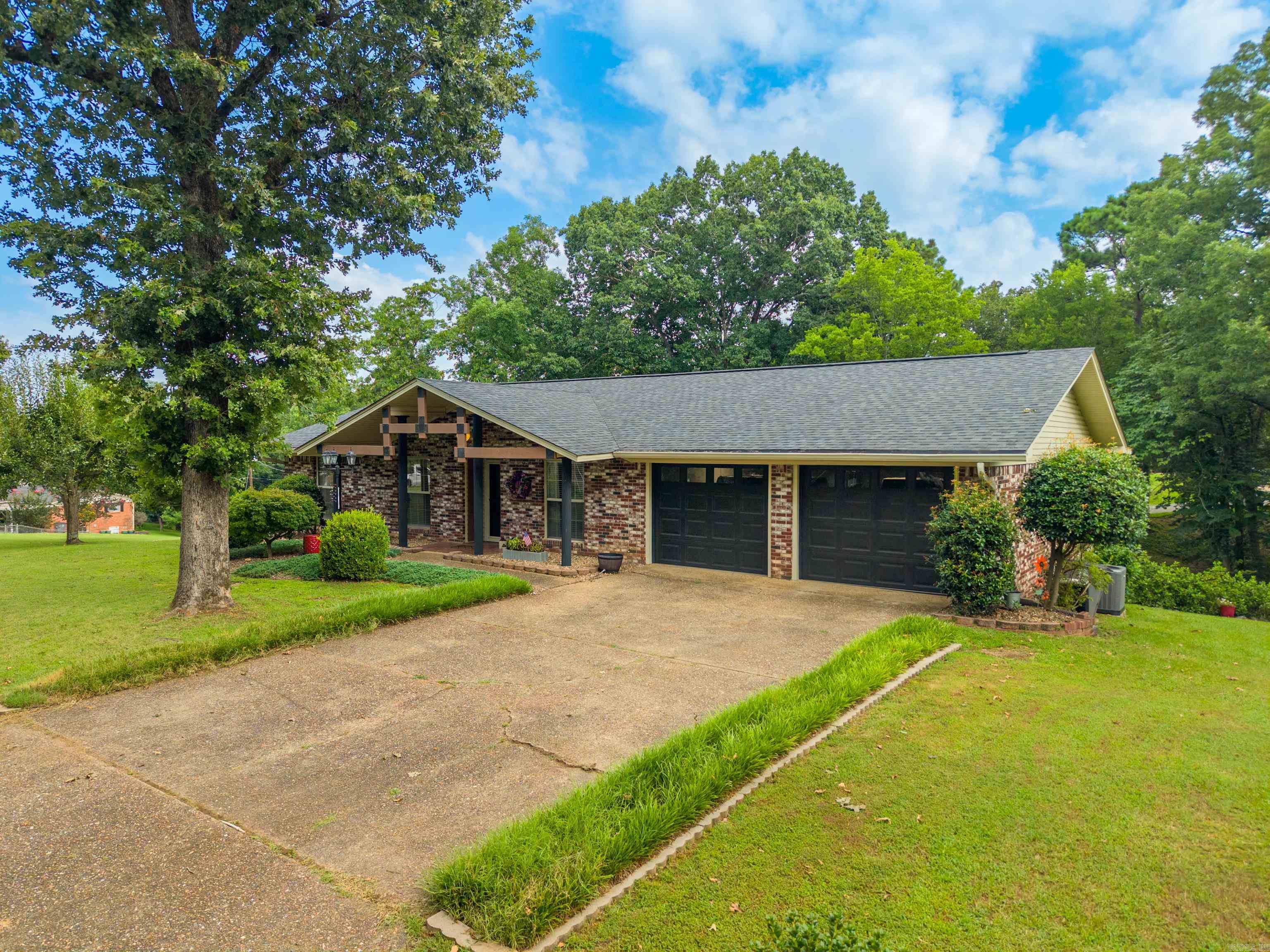 Spacious, beautifully updated, and perfectly located! This exceptional 5-bedroom, 3-bath home offers approximately 3,200 square feet of versatile living space on 1.7 acres, combining modern updates with room to spread out both inside and out.  The main level features a bright, inviting living room with a cozy fireplace, an updated kitchen, formal dining room, three spacious bedrooms, two beautifully updated bathrooms, convenient laundry hookups, and an attached two-car garage.  Downstairs is ideal for entertaining or multi-generational living, offering two additional bedrooms or flexible bonus rooms, a full bathroom, a second living area with its own fireplace, a large wet bar, a dedicated laundry room, and a second attached two-car garage. Outside, you'll enjoy 1.7 acres with plenty of space for outdoor entertaining, gardening, recreation, or simply relaxing while still benefiting from a convenient central location close to shopping, dining, schools, and everyday amenities. With extensive updates throughout, four garage spaces, two living areas, two fireplaces, and a flexible floor plan that adapts to your lifestyle, this move-in-ready property is one you definitely want to see.