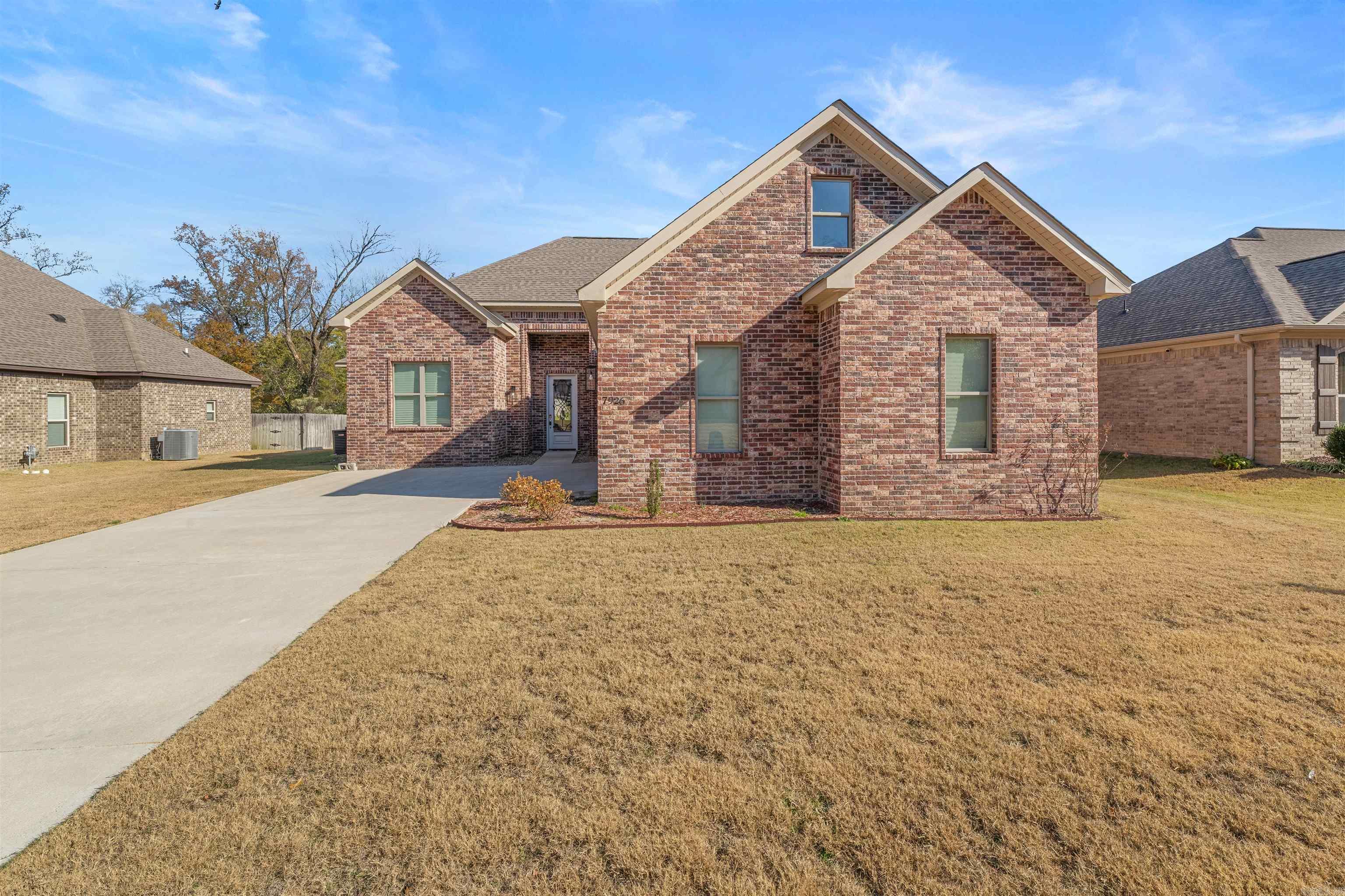 This home is a bargain and is priced under appraised value!  Built in 2023, this all-brick home in Hurricane Lake Estates blends a fresh feel with a comfortable, open layout. The kitchen, dining and living areas flow together, making it easy to cook, gather and entertain. The kitchen features granite countertops, an island with a sink and a pantry that offers plenty of space. The living area has built-ins and an accent wall that adds a nice touch. The primary bedroom is set apart from the others and includes an ensuite with a soaker tub, separate shower and two walk-in closets. On the opposite side of the home are two additional bedrooms and a full bathroom. Upstairs, you’ll find a landing area at the top of the stairs that works well as an office space, a full bathroom and a fourth bedroom,  a large bonus room that could be a 5th bedroom is needed, along with plenty of floored attic storage. Outside, you’ll enjoy an oversized two-car garage, a private backyard with a partial lake view and a covered patio for relaxing or entertaining. “Arvest employees, directors and their family members are ineligible to purchase Arvest’s bank-owned properties.”