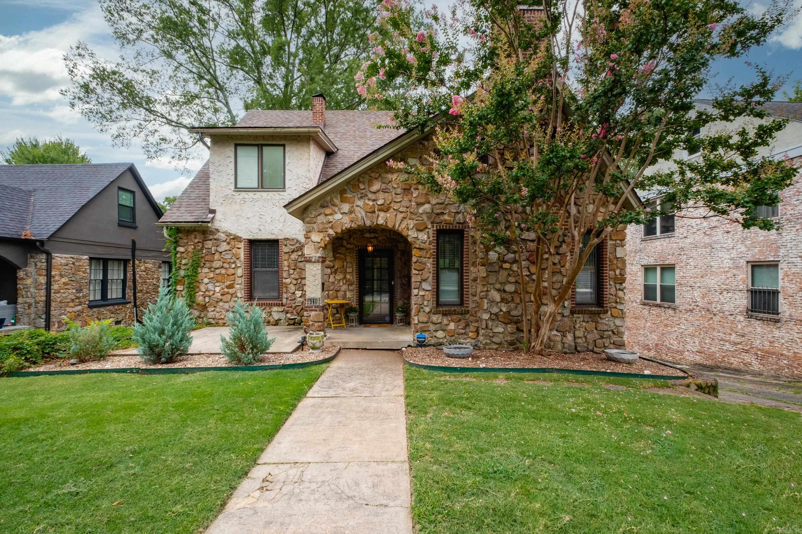 Located in the heart of Hillcrest, this charming 4-bedroom, 2.5-bath home offers walkability, character, and ample space both inside and out. Listed on the Arkansas Historic Registry, the home blends classic appeal with modern updates. A spacious composite deck overlooks the fully fenced backyard, perfect for outdoor entertaining. Recent improvements include a full kitchen remodel with quartz countertops, new backsplash, new flooring, sink, updated LED lighting, and custom open shelving. Major system updates include new HVAC, ductwork, modern thermostats, and electrical upgrade in 2024. Roof replaced in 2021. The layout features 3 bedrooms and 1 bath upstairs, a main-floor bedroom with a beautifully renovated bath, and a basement with a half bath, laundry, storage, and a 1-car garage plus extra workroom & storage. Parking is plentiful including 2 covered spots beneath the deck. Don’t miss this rare Hillcrest gem with space, updates, and unbeatable location.