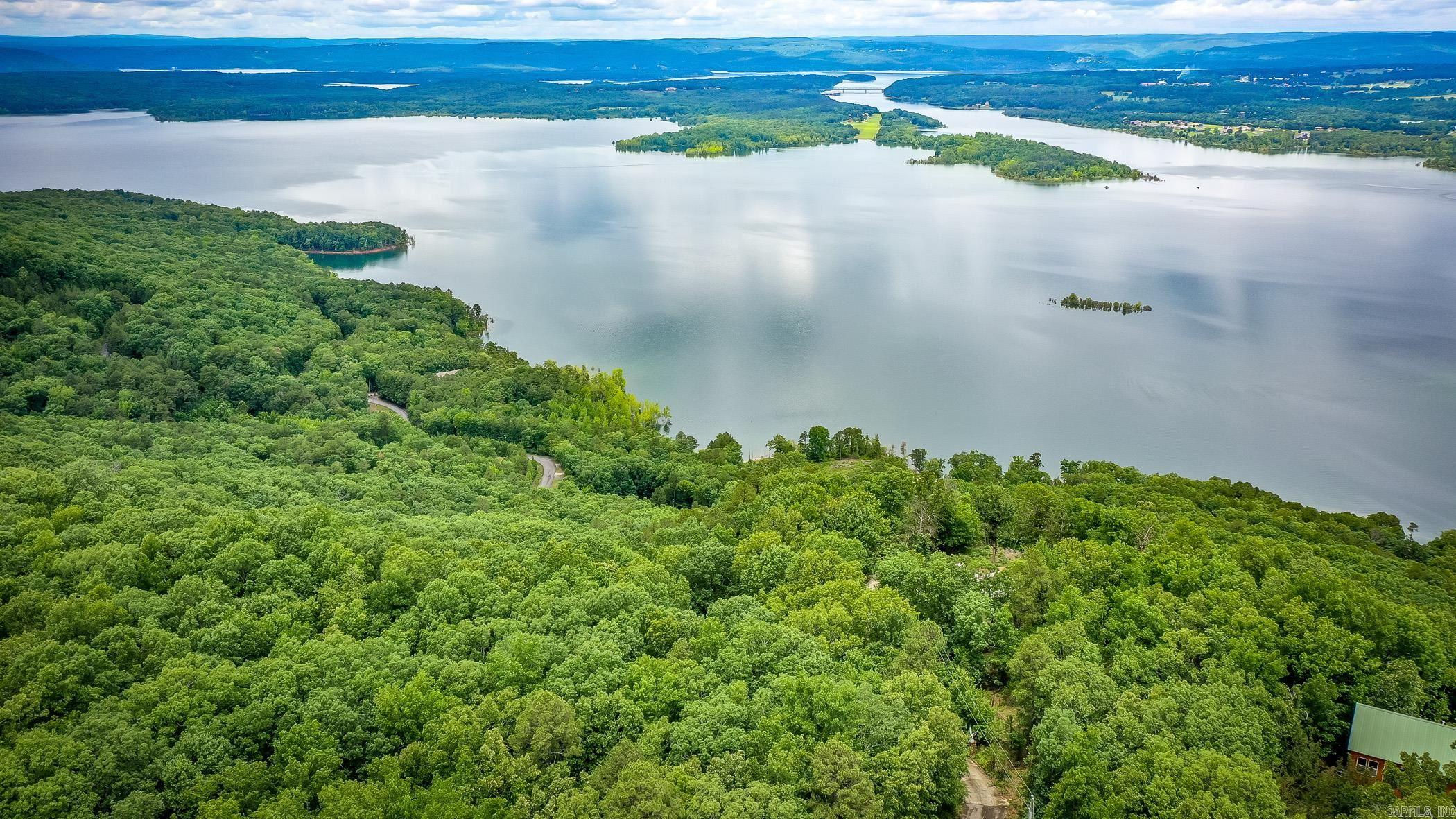 Experience breathtaking, panoramic vistas from this exceptional 5.33-acre lot situated off Diamond Bluff Road. Perched above the shimmering waters, this property boasts commanding views over the expansive lake and down the scenic Narrows—offering sunsets and sunrises that will leave you in awe. The site previously featured a 3,000+ sq ft home, which was recently cleared following a fire, making this the perfect blank canvas for your custom retreat. All the essentials are already in place, including a gated driveway, established landscaping, septic, water, excavation and on-site power—saving you both time and expense as you bring your vision to life. Embrace the tranquil lifestyle with easy access to three nearby marinas, ensuring endless opportunities for boating, fishing, and lake adventures. Whether you’re seeking a serene escape or an entertainer’s paradise, this rare offering is ready for you to build the luxury home of your dreams. Don't miss out on this incredible opportunity—your slice of paradise awaits!  See Attached Documents