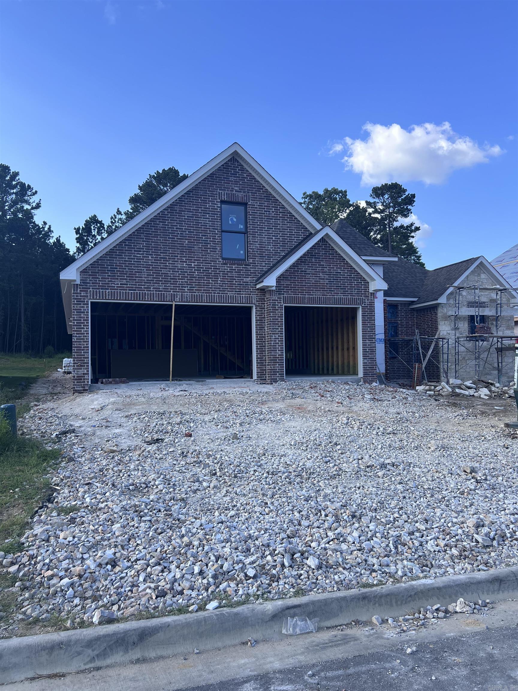 New Construction Home in Red Oak Ridge.  Carriage Custom Homes will complete this home late summer of 2026.  Offering 3 Bedrooms, two and one half baths, bonus room upstairs and a study on the main level.  Beautiful finishes that you expect in a Carriage Home.  Large kitchen Island anchors the kitchen space that opens into the living room with a gas log fireplace. 12 ft. ceilings.  The primary suite offers spacious custom closet and beautifully appointed primary bath.  Neighborhood amenities include, gated entrance, walking paths, hiking tails, community pool, two private lakes for fishing and recreation. Square feet is approximate, please feel free to measure. Tax information is available from Garland County Tax Accessor.