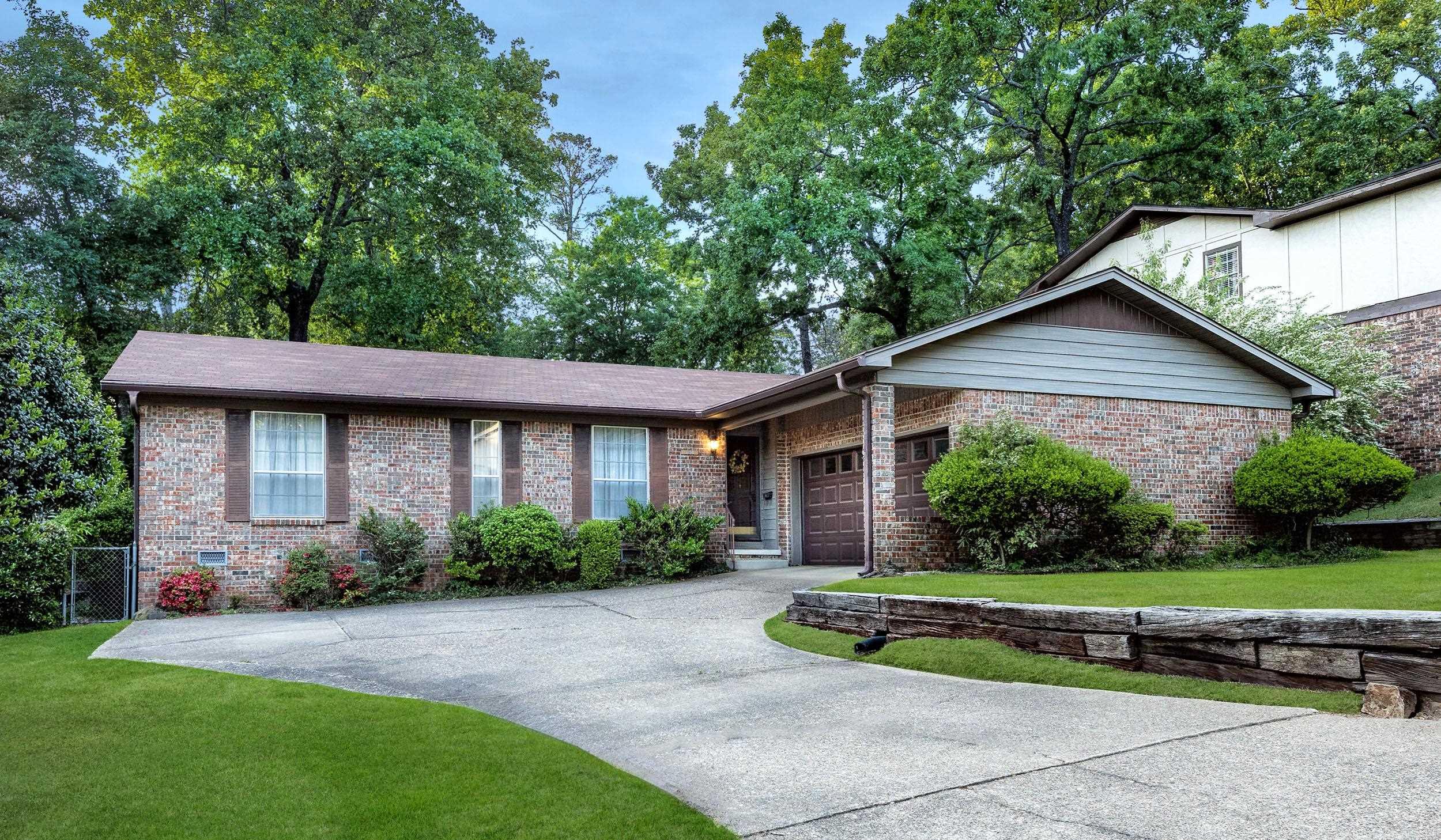 Located in the established Echo Valley subdivision of West Little Rock, this well-maintained one-level home offers 3 bedrooms, 2 baths, and approx 2100 sq. ft. Built in 1973, the home features hardwood floors in the living and dining rooms and a functional layout with an eat-in kitchen—refrigerator conveys, and a cozy den with a fireplace and built-ins. A spacious sunroom, added in 1985, showcases a vaulted ceiling and its own mini-split system, creating a comfortable year-round retreat.  The primary suite includes two closets and a private bath with an updated shower. Major updates include a whole house generator and new air conditioning system, both installed in 2025. Exterior features include durable steel siding, a fully fenced backyard, French drains, storm drainage, and on a crawlspace. Additional highlights include a two-car garage with automatic opener. Convenient location close to shopping, dining, and amenities.