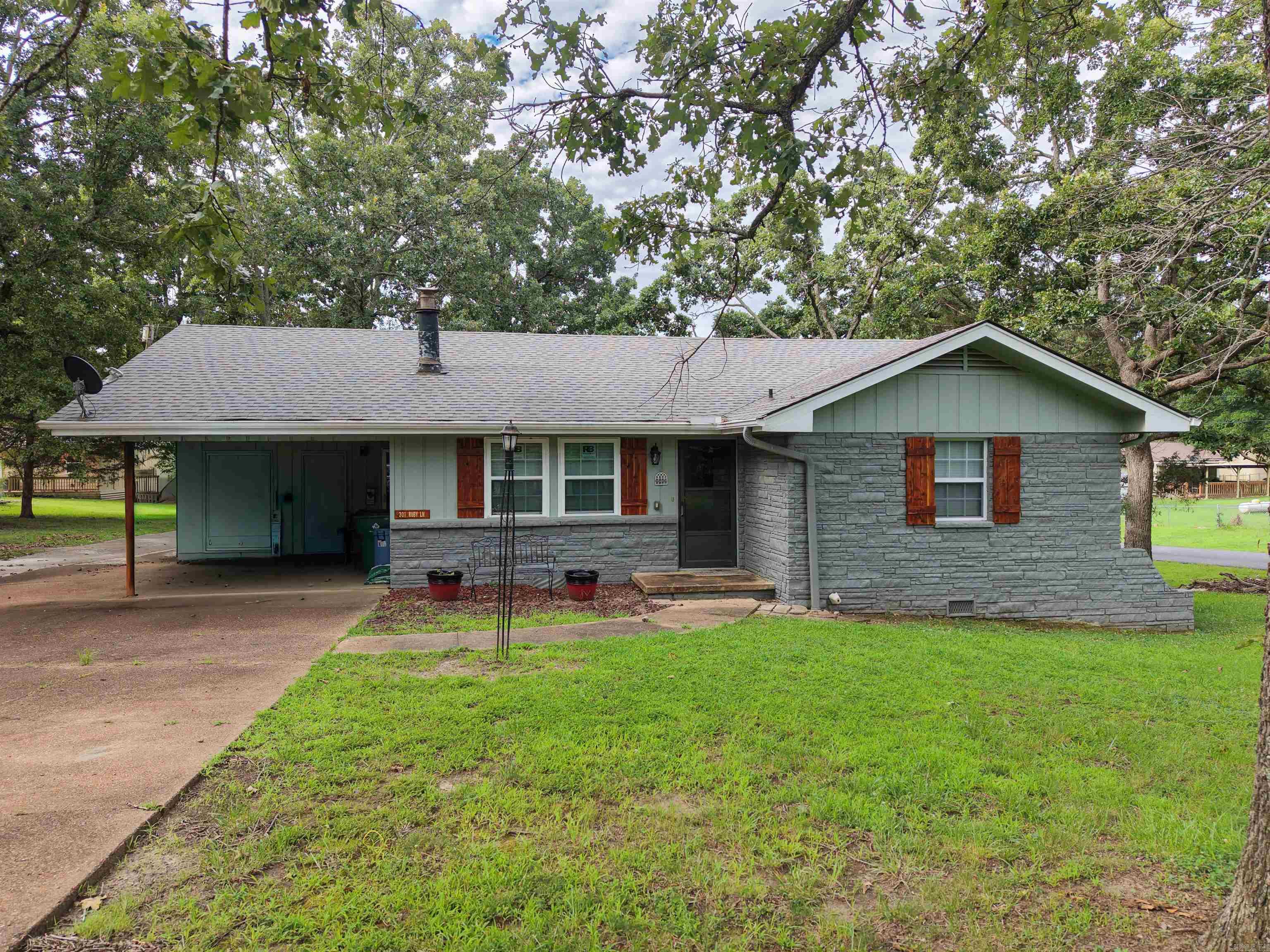Charming home near Crown Lake on 2 large lots! This adorable lake home is situated in a great location on a large corner lot, close to Crown Lake, Turkey Mountain Golf Course, and all of the other amenities Horseshoe Bend has to offer! With an updated exterior and interior, the home has lots of storage space, has been well-maintained and is move-in ready! With the sunroom, attached screened-in porch, and back deck, this property provides ample space to relax or entertain family/friends. On the additional lot sits a building that has electricity ran to it, with a window unit, making it heated and cooled- great for a workshop, storage, or even potentially a place to house guests for the night. Mature shade trees, a 1-car carport, and a large parking pad providing plenty of space for guests to park, this home has everything you need for a peaceful lake home to spend time by yourself, with loved ones, or even make it a vacation rental! Call for a viewing or additional information-- let's make it yours today!