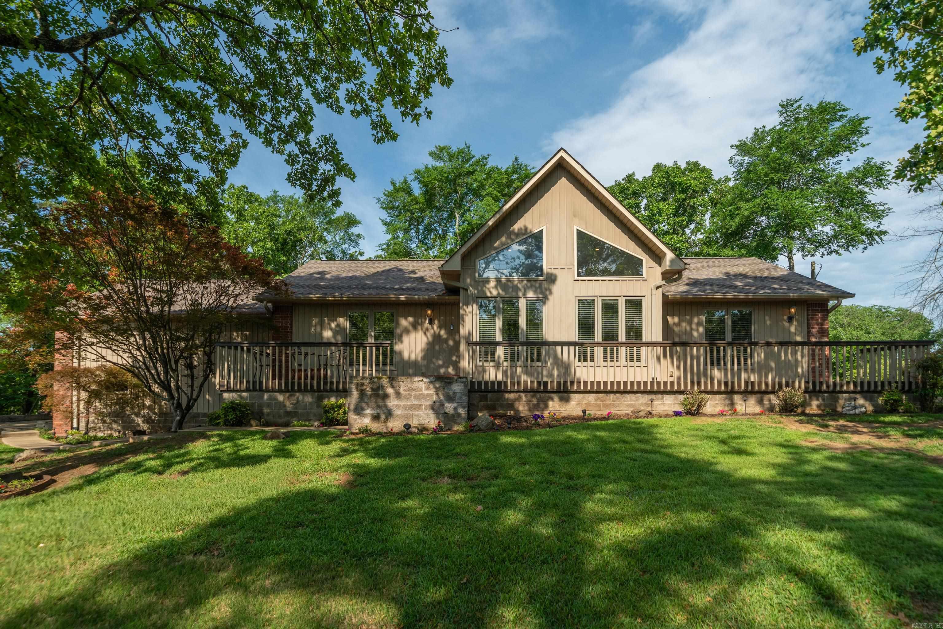 Enjoy beautiful views and privacy in this one level home that feels like a treehouse retreat surrounded by trees, yet just minutes from shopping, grocery stores, hospitals, and restaurants. Inside features vaulted ceilings, large windows, hardwood floors, granite countertops, and crown molding throughout. The oversized garage plus two large storage rooms provide plenty of space for storage and hobbies. Enjoy the outdoors with covered decks, an open patio, mature landscaping, and a sprinkler system--all designed for easy, low maintenance living.
